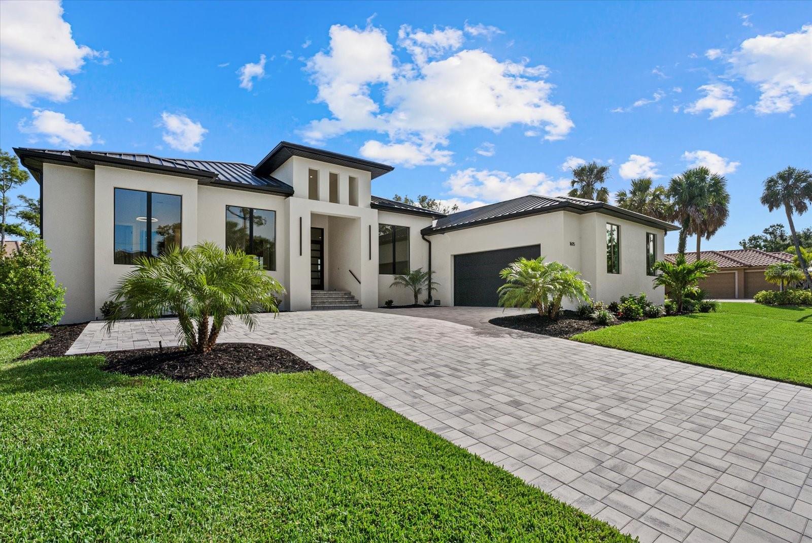 Step into elevated coastal living in this impeccably designed 3-bedroom, 2.5-bath plus an outside patio bathroom + den (or fourth bedroom) home that effortlessly blends luxury, functionality, and location. From the moment you arrive, the stunning curb appeal welcomes you with a wide paved driveway that comfortably accommodates up to six vehicles, a standing seam metal roof (24 gauge, 1 3/4 inch standing seam roof with Batt R-37 insulation), and a spacious epoxy-coated garage. The garage, windows, ceilings, and doors are all insulated. The community private boat ramp and dock offer access to open waters — a rare gem for boat lovers. Plus, the secured community parking lot provides extra space for your boat, RV, or extra vehicles.
Inside, soaring ceilings up to 13 feet create an airy, open ambiance, while luxury vinyl flooring and porcelain tile flow seamlessly throughout. The heart of the home is a chef’s dream kitchen featuring quartz countertops, an 11-foot waterfall island with additional cabinetry for smart storage, a built in iron board, and a gleaming central vacuum system for easy maintenance. Custom LED-lit shelving and a striking stone fireplace add warmth and character to the open-concept living space.
Need a home office or guest room? A flexible "bonus" room offers the perfect opportunity to create a fourth bedroom, a quiet workspace, or even a cozy den. The oversized master suite includes a spa-inspired bathroom with a beautifully tiled, walk-in shower that feels like your own private retreat.
Step outside to your large enclosed patio and fully equipped outdoor kitchen adorned with stainless steel appliances, granite countertops, a hideaway sink, and stone finishes — ideal for entertaining year-round. And when you’re ready to cool off or add even more value, there’s room to build your dream pool (which has all been prepared). Located just 3 miles from Nokomis Beach and a few minutes from I-75, this home is perfectly situated for convenience and coastal adventure.
This home is more than a place to live — it’s a lifestyle. One that combines modern luxury with the laid-back spirit of the Gulf Coast. Come experience it for yourself.
One or more photo(s) has been virtually staged.