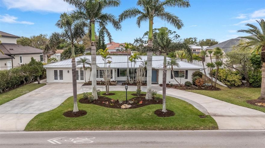 Welcome to 441 Bayshore Drive, and exceptional coastal retreat on prestigious Bayshore Drive on Venice Island.  Perfectly positioned just across the street from the water, this one level home captures serene water views and refreshing breezes, without direct waterfront maintenance.  A perfect blend of coastal charm with modern upgrades in this beautifully renovated home, ideally located just 0.6 miles from the beach and Freedom Boat Club. Enjoy views of the bay from the front living room and porch, and take a short bike ride to the Venice Yacht Club, historic downtown, parks, shops, restaurants, and theater.

At the heart of the home is a gorgeous chef’s kitchen featuring a stunning 10' island, quartz countertops, custom tile backsplash, and new Forno appliances including a refrigerator, dishwasher, microwave, and induction range—perfect for both entertaining and everyday living. The thoughtfully designed layout offers two master suites, providing exceptional comfort and privacy for owners and guests.

This home has been extensively updated with attention to both style and function, including a new metal roof (2026) with warranty, freshly painted interior and exterior, and a circular drive for added convenience and curb appeal. Interior upgrades include custom shiplap, French doors, recessed lighting, crown molding, and new ceiling fans throughout, Butler's pantry with lots storage, along with new vanities, fixtures, faucets, and custom ceramic tile in the bathrooms. Additional features include new locks and smart thermostats for modern living.

Step outside to your private Florida oasis with a resurfaced pool (2023), new screened lanai (2025), and new pool pump (2025). The expansive backyard offers endless possibilities—perfect for pets, a playground, gardening, or enjoying natural wildlife. The property also features new sod and irrigation on the side and rear, plus irrigation and lighting in the front yard, and fresh landscaping with birds of paradise, a mango tree, and milkweed to attract butterflies.

Additional upgrades include a Culligan water softener (2023) and a new 50-gallon water heater with booster pump for on-demand hot water, plus Maytag washer and dryer (2023).

This move-in-ready home blends thoughtful upgrades, flexible living, and an unbeatable location—offering the very best of Florida coastal living- a rare opportunity to own in one of Venice Island's most sought after spots- where luxury, location and lifestyle meet.