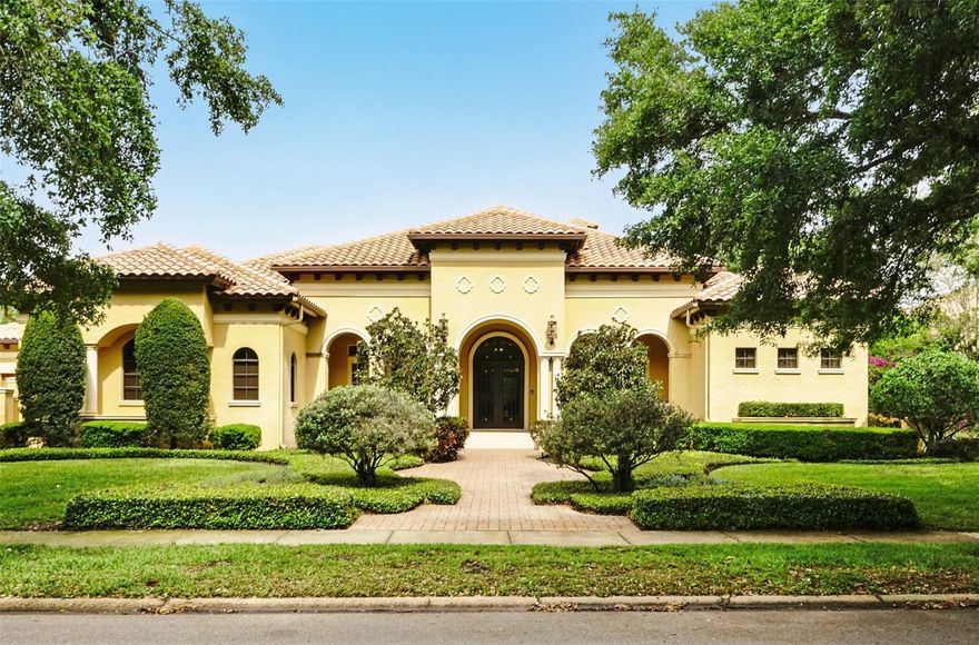 Luxury Meets Comfort in This Stunning Custom Windermere Estate!  Experience the pinnacle of Florida living in this immaculate home, designed with elegance and functionality in mind. Spanning an impressive 6,000 square feet, this single-story masterpiece boasts exceptional architectural details, intricate ceiling designs, and luxurious finishes throughout. Step through the grand wrought iron and glass entry doors into the exquisite loggia, where the spacious grand salon welcomes you with a stately gas fireplace and French doors opening to a breathtaking poolside retreat. The seamless indoor-outdoor flow continues in the expansive family room, where disappearing pocket glass doors reveal a resort-style screened pool and spa with enchanting water features, “stepping stones,” a summer kitchen, and an outdoor fireplace—perfect for entertaining.  The chef’s dream kitchen is a work of art, equipped with top-tier Wolf & SubZero appliances, a large center island, a hidden walk-in pantry, a butler’s serving pantry, and a buffet counter—all complemented by a stylish casual dining area.  Designed for ultimate relaxation, the luxurious master suite is a private oasis, featuring a spacious sitting area, elegant tray ceilings, and a lavish spa-inspired bath with a bidet and an expansive walk-in wardrobe. A private exercise lounge and an adjoining, richly detailed study with wood flooring and exposed beams complete the master wing.  On the opposite side, four generously sized guest suites—each with private en-suite baths and walk-in closets—surround a spacious game room, ensuring comfort and privacy for family and guests.  Set on a lushly landscaped lot, this stunning residence also offers two 2-car garages, a brick-paver motor court, and a picture-perfect setting in one of Windermere’s most prestigious communities.  Residents enjoy 24-hour manned security, serene English garden parks, a lakeside gazebo, and a beautifully landscaped waterscaped entry.  Don’t miss the opportunity to own this extraordinary home, where every detail has been thoughtfully designed to offer elegance, comfort, and the best of Florida living!