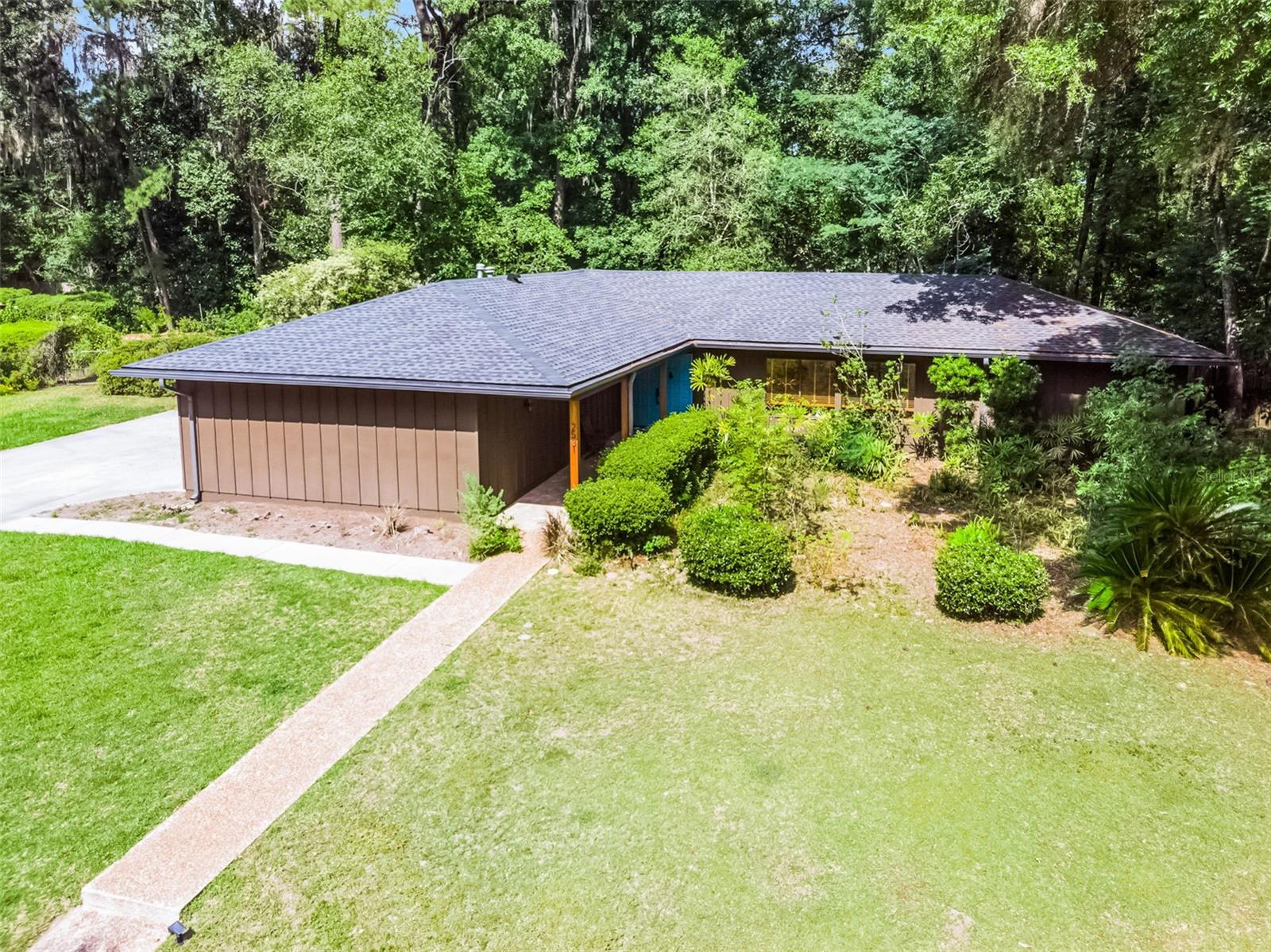 Spacious and beautifully updated 3-bedroom, 2-bath home located in the heart of Gainesville. This split floor plan features hardwood flooring in the living room, dining room and bedrooms. The home also has large windows that bring in an abundance of natural light, and a large Florida Room perfect for relaxing or entertaining. The kitchen includes a large window overlooking the backyard, and lots of counter space. Both the primary and second bedrooms offer sliding glass doors for easy outdoor access.
Enjoy the outdoors on a large, fully fenced backyard with mature landscaping, plenty of shade and space to relax or entertain. Major updates include a new roof (2023) and a new dishwasher (2022). The extended garage offers additional space—perfect for a workshop, extra storage, or both. Conveniently located near shopping, dining, and all that Gainesville has to offer. Don’t miss your chance to see this beautiful home.