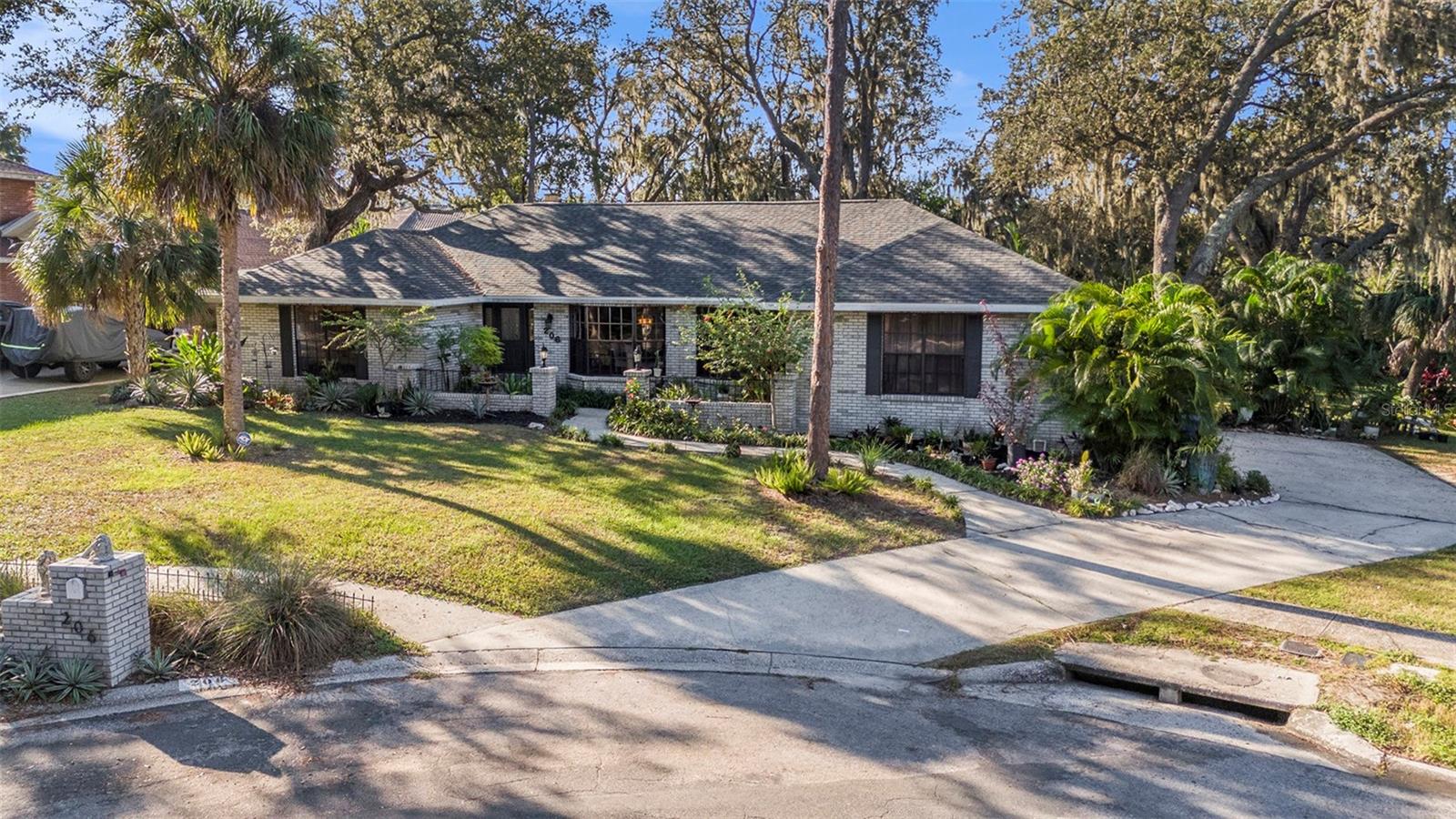 Your serene oasis awaits on over 1/2 acre, tucked away at the end of a peaceful cul-de-sac beneath a majestic tree canopy on one of the most desirable streets in Brandon! This beautifully maintained 4-bedroom, 2-bath pool home blends timeless character with modern comfort and offers a backyard retreat that feels like your own private park. Step inside and you’ll immediately feel the warmth and personality that make this home stand apart. Vaulted ceilings with striking wooden beams, a stone-surround wood-burning fireplace, and expansive bay windows overlooking lush greenery fill the living spaces with light and charm. The open floor plan flows effortlessly from the spacious living room to the dining and kitchen areas, perfect for entertaining or everyday comfort. The kitchen features rich wood cabinetry, vibrant tile accents, and a wide breakfast bar that opens to a sunny eat-in nook with pool and garden views. The split bedroom layout offers privacy for the primary suite, which is separated from the secondary bedrooms. Enjoy peace of mind with recent updates including a NEW ROOF (September 2025), new water heater (2025), new dishwasher, resurfaced & retiled 27,000-gallon, 9-foot-deep pool, and updated bathrooms. French doors lead to your screen-enclosed pool and lanai, surrounded by mature tropical landscaping and the soothing sounds of nature. All of this with an oversized side-load garage, 6-zone irrigation, and no HOA or CDD! Outside, the massive backyard offers endless possibilities — from gatherings and pets at play to gardening or simply relaxing beneath the sprawling oak trees. Conveniently located near US-301, I-75, and the Selmon Expressway, this home combines a serene, tucked-away setting with easy access to shopping, and dining. Located in the sought-after Bloomingdale High School district, this home offers space, privacy, and pride of ownership in a neighborhood that feels like home the moment you arrive. Tampa International Airport is 35 mins away, and it is just over 1-hour from Disney, Universal, Sea World, and the beautiful, award-winning bay-area beaches. If you’ve been searching for a home that feels like Florida living at its best with space, privacy, and undeniable charm, this one could be it!