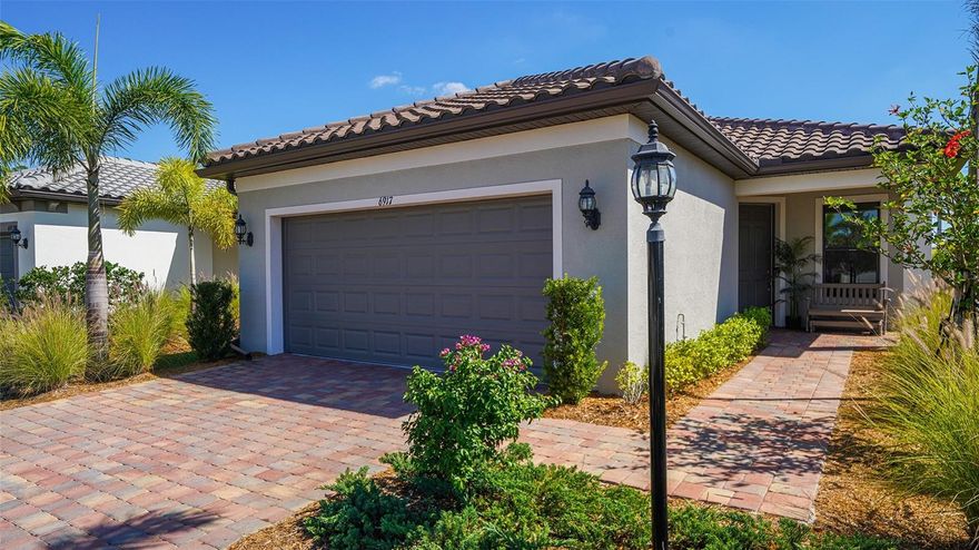 PRICE IMPROVEMENT! Live your best life in this luxurious resort-style, 55-plus gated community in Del Webb at Lakewood Ranch. You'll surely enjoy endless days and nights in your own piece of paradise. Everything inside this charming home is designed with your needs in mind. This two bedroom, two bath home features a Contour floor plan with a den. The den is large enough to accommodate a queen size bed. The great room has sliders to a screened lanai where you can relax and enjoy the tranquil lake views. The upgraded gourmet kitchen overlooks the dining and living area and features granite counters, decorative glass tile backsplash, stainless steel appliances, a gas range and upgraded cabinetry. The primary suite is spacious with a walk-in shower, dual sink vanity, granite counters and a private water closet. Additional features include a tile roof, rain gutters, a paver drive and lanai deck, a tankless water heater, Galvanized hurricane shutters, double-pane insulated windows, an oversized extended two-car garage with a utility tub and more. The home is located on a cul-de-sac within a short walk to the Del Webb Club House. The maintenance-free grounds allow homeowners to get out and enjoy the resort-style amenities, which include the Lake House Restaurant and Bar, fire pit lounge areas, a 21,000 square foot Del Webb Club House with a state-of-the-art fitness center, a clubhouse with daily activities, a full-time lifestyle director, concerts, card and game room, a resort-style pool with lap lanes, a spa, tennis, bocce, pickleball, a dog park and miles of walking trails. Close to shopping, dining, medical facilities, airports and world-class beaches. Come tour this home and the Del Webb community and see how amazing it is for yourself!