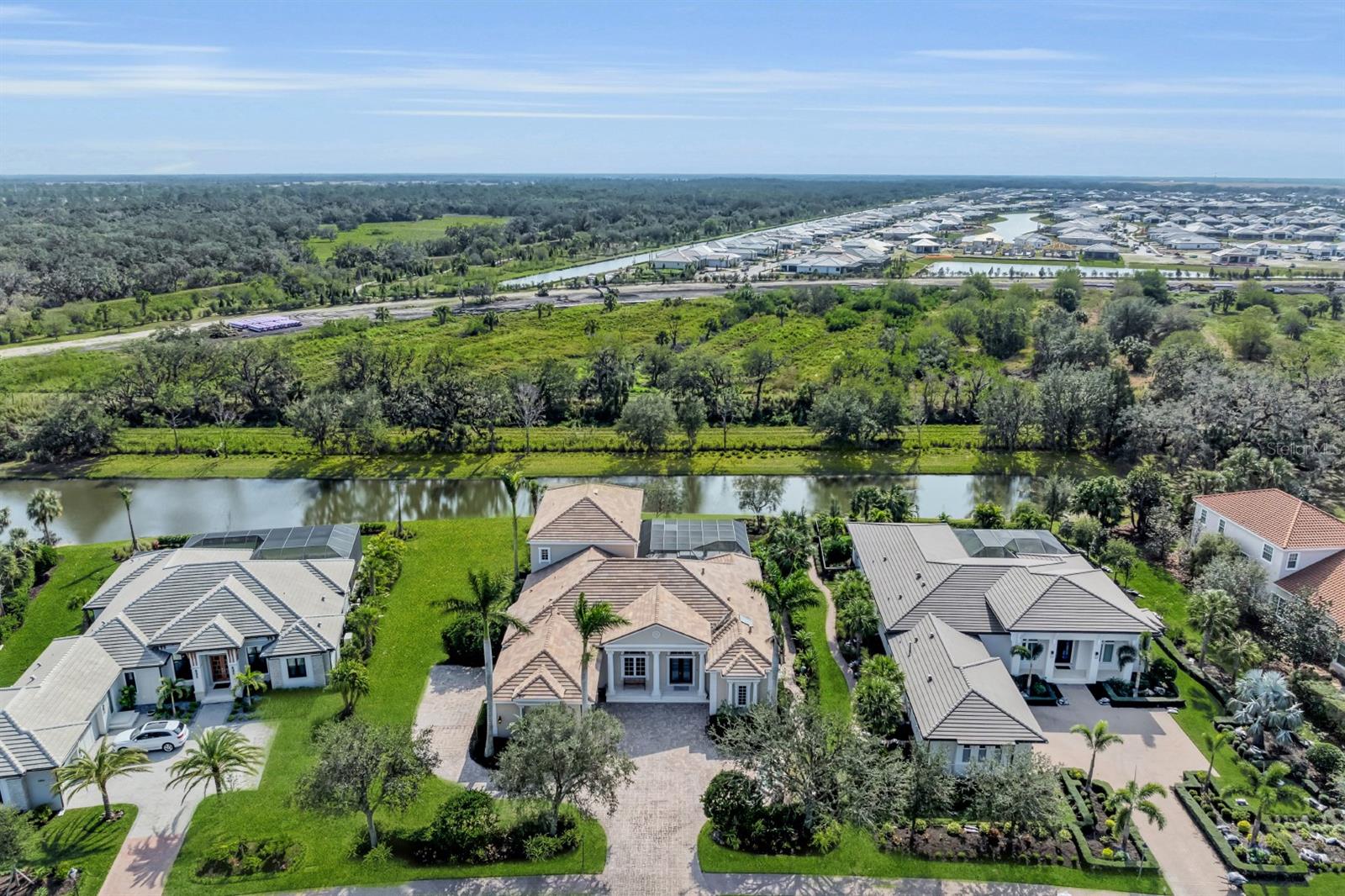This custom residence in the prestigious Founders Club blends timeless classical architecture with modern design. The fully renovated interior and outdoor living areas cater to a luxurious and comfortable lifestyle and will please discerning buyers. Perfect for those who seek tranquility and privacy with breathtaking views, as this home is set against the backdrop of a beautiful preserve. The exterior includes a semi-circle driveway, a charming fountain, and a split three-car garage. Through the double-door entry, an impressive foyer leads to a grand living area with a striking fireplace, soaring ceilings with tray details, crown molding, and dazzling lighting. 10' sliding glass doors offer stunning views and fill the main living areas with natural sunlight. The dining space and airy great room off the kitchen offer ideal spaces for both graceful dinner parties and casual entertaining. The gourmet kitchen is a chef's dream, with all new solid wood double-stacked cabinets, natural Taj Mahal quartzite, a state-of-the-art Wolf double oven gas range, a Sub-Zero oversized refrigerator, and a 72-bottle wine chiller. A pantry and butler area add convenience for the home chef. On the first level, the well-appointed all-new owner’s suite and spa bath is a place to soothe the senses and unwind after a long day. A cozy study with a gas fireplace and a separate library with patio provides peaceful spaces for work and relaxation. Two spacious King guest en-suites on separate wings provide plenty of space on the first level. A personal elevator ensures easy access to the second level for everyone. The upstairs loft with kitchenette and a separate King suite and full bathroom provides the perfect retreat for guests or multigenerational families, ensuring everyone feels at home. The outdoor terrace off the second-floor wraps around the back of the home and overlooks the protected preserve. Exquisite natural travertine limestone flooring and French oak flooring are featured throughout, adding a touch of timeless elegance. The cascading heated pool and spa have been freshly updated and feature newer equipment. Lush landscaping creates an outdoor oasis and compliments the natural setting. The enchanting outdoor living area has shell-stone pavers, a deep covered lanai with shaded seating areas, and an extended clear view panoramic screen. All new landscape lighting enhances the home in the evening. A new whole home generator offers peace of mind. Lovingly renovated with meticulous attention to detail and no expense spared, this home is ready for you to create lasting memories and must be experienced to be truly appreciated. With four newer AC units and Culligan water filtration this home provides modern style and comfort. The acclaimed Robert Trent Jones Jr. course, the only walkable golf course in the region, offers easy tee times. Optional golf and social memberships. Neighborhood amenities include a stately clubhouse with fitness center, restaurant, veranda, social events, Har-Tru tennis courts, and on-site yoga and Pilates classes. Located in desirable flood zone X, you'll be 30 minutes to SRQ airport and world-famous Siesta Key and Lido beaches. This prime location with easy access to grocers, medical facilities, and world class shops and restaurants is perfect for golfers, nature lovers, and those who want to live the ultimate Sarasota lifestyle.