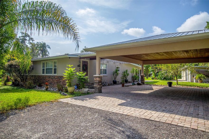 Country living with benefits! A-2 zoning. Bring your chickens, fresh eggs every morning.  This .63 Acre property has a newly painted and remodeled 4 bedroom / 2.5 bath home with a huge out building...1000sqft workshop for storage! 
 
 The remodeled kitchen has stainless appliances, hickory cabinets and granite countertops. Tile throughout the main living areas, cherry flooring in dining and master bedroom.  
 
 A beautiful and convenient two car carport attached to the main house has gorgeous tongue and groove ceiling.    
 
 EIFS upgraded exterior finish creates an energy efficient environment.  This home boast a newer metal roof that will last.  
 
Must see lot on a cul de sac has Cypress trees, Avocado, Plum trees and more.  Located only two miles to the fish camp and Sunrail is in process of adding a stop 3 minutes from this property. Excellent transportation opportunity!  Come see this property, it will not last.