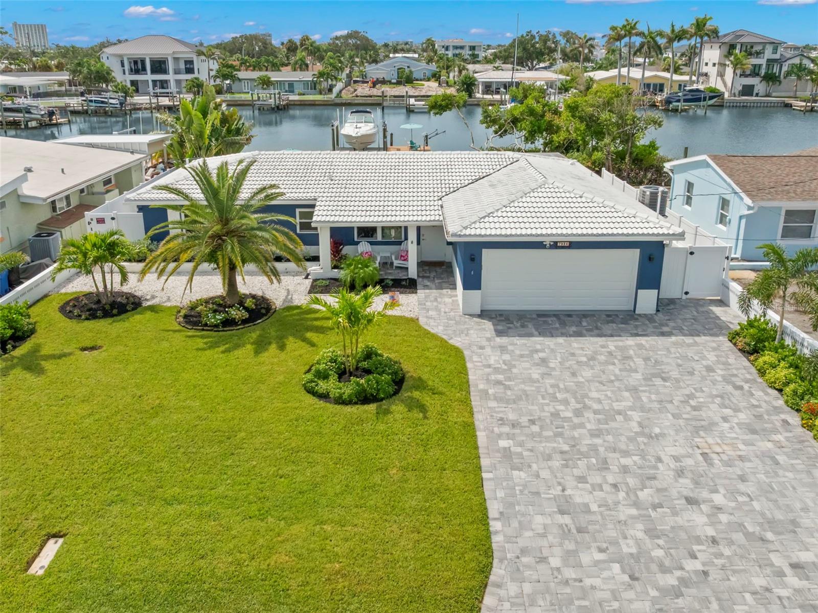 Welcome to this stunning, waterfront retreat with exquisite features throughout and completely remodeled in 2025. This beautiful 3-bedroom, 2-bathroom home is perfectly situated on the tranquil intracoastal waters, offering breathtaking views and easy access to fishing, kayaking, and dolphin watching. Are you a boating enthusiast? The 1997 SeaRay/290 Sunseeker conveys with house! Love the landscaping and pavers? This 50K+ exterior makeover was completed in 2023, rivaling any house on the block and offering exceptional curb appeal.
Step inside to discover a beautifully appointed interior, charming terrazzo floors, and an updated kitchen featuring new appliances and a high-end Wolf stove. The living room and dining room are open and bright with breathtaking water views. Your spacious primary bedroom offers ample room for a King bed and boasts an en suite bath plus more gorgeous water views. The second and third bedrooms are equally inviting with the latter ideal for a children’s playroom, office, workout area or bunk beds. Other upgrades include quartz countertops and plumbing in 2022 plus HVAC, cabinets, interior/exterior paint, interior doors, kitchen appliances, bathroom vanities, and more in 2024. All the mid-century charm with modern conveniences!
The true gem of this property is it’s impressive water frontage, heated pool, dock, and boat lift. You’ll enjoy launching a paddle board or jet ski right from your private dock, sipping morning coffee poolside or relaxing with a sunset cocktail while dolphins play. Waterfront living is more than an amenity but a lifestyle. Book your showing today, and embrace the perfect blend of luxury, comfort, and natural beauty with this exceptional coastal retreat. Because Life is Better in Flip-Flops!