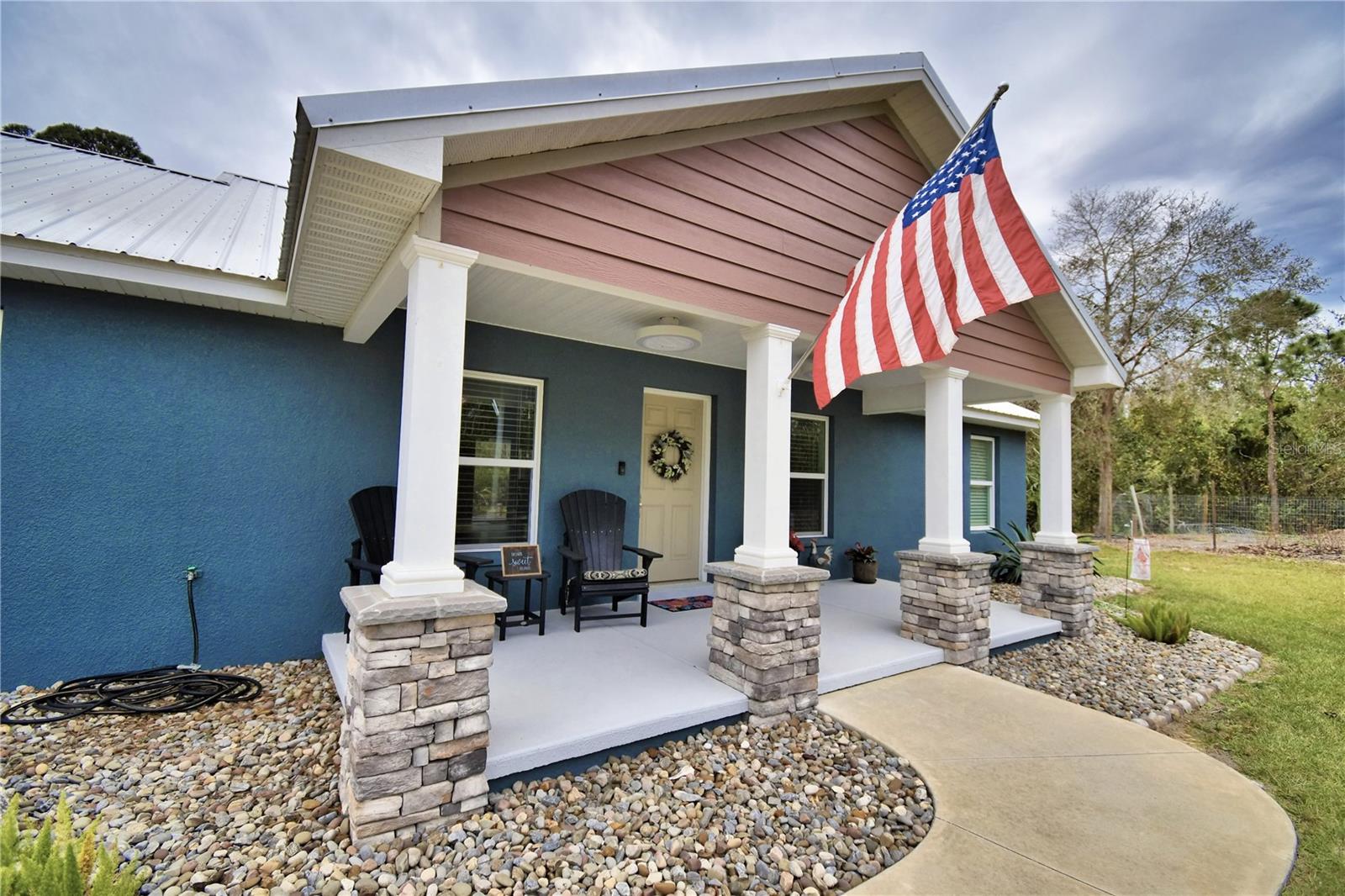 Bring on the offers!!!!!3rd Bedroom an easy option with it's own Mini Split (See plan drawing in attachments). 7.58 acres currently a 2 BR 2 BA home with Lake Reedy Access of beautiful, natural Florida land, abundance of wildlife and access to bass fishing heaven & FAA approved for Seaplanes in Lake Reedy. Unique in so many ways. Horses are allowed according to the HOA but limits. Beautiful landscaping with palms, river rock and ornamentals welcome you to the front entrance. Exterior colors, along with columns accented with stone, draws you to rocking chairs and enjoy the serene natural beauty and sounds of nature. This stunning home offers over 3000 sq. feet under a metal roof. As soon as you enter the home you are greeted by the open perfectly designed floor plan with great room, dining room & amazing kitchen. Kitchen features granite counters that flow up for the back splash, deep sink, soft close drawers, GE stainless appliances, wood cabinetry & nice size island also with granite top. Crown molding accents this great area along with both bedrooms. Color scheme is crisp & bright, the luxury laminate flooring is gorgeous throughout the home. The hall from the kitchen to the garage takes you by the nice sized open shelved pantry & coffee bar & into laundry room where a granite countertop flows above the LG Thin Q washer & dryer making a perfect folding area and continues to and around the laundry sink. The master bedroom offers beautiful lighting and custom Bali blinds, ensuite master bath boasts of tile flooring, a walk in closet with shelving, tall counters with dual sinks and a very large ADA walk in shower with dual shower heads including a rain shower. Adjacent to the master thru French doors is a sunroom with a wall of windows and custom Bali blinds allowing the view of nature at its best and an entrance to the screened lanai. In this split floorplan the 2nd bedroom is like a 2nd master just beyond the living room/kitchen area. Oversized closet, dual access bathroom with large walk in shower, tall counters and granite make this perfect for the ensuite, guests or workshop in garage. The lanai can also be entered thru French doors off the dining room offering the perfect area to enjoy morning coffee or relax at the end of the day. Beyond the lanai a pan roof covers the outdoor kitchen area complete with brick pavers, sink, ceiling fan, gutters and room for a grill. Just steps away from the outdoor kitchen you will be amazed at the large brick paver area where the fire pit awaits. This area is perfect for quiet personal enjoyment or gatherings with friends and venturing down the cleared paths on the property or enjoying fruit from the orange, avocado or grapefruit trees. The garage is over 900 sq ft and designed for 3 cars. It has two garage doors so has plenty of room for golf cart or motorcycles, etc. and work space. Some of the Kobalt cabinets shown are staying as well as a mini split AC unit. The 40 X 30 concrete floor pole barn has electricity and water is nearby as well as a storage shed. Lake Reedy is known as one of the best fishing lakes in this area. This home not only has access to lakefront on Lake Reedy but you also have access to the public boat ramp that is a nice ramp with floating dock, restrooms and not far away. Don't miss out on this one. Schedule your private showing today and make this your forever home. ***These photos show it furnished. It is not furnished any longer***