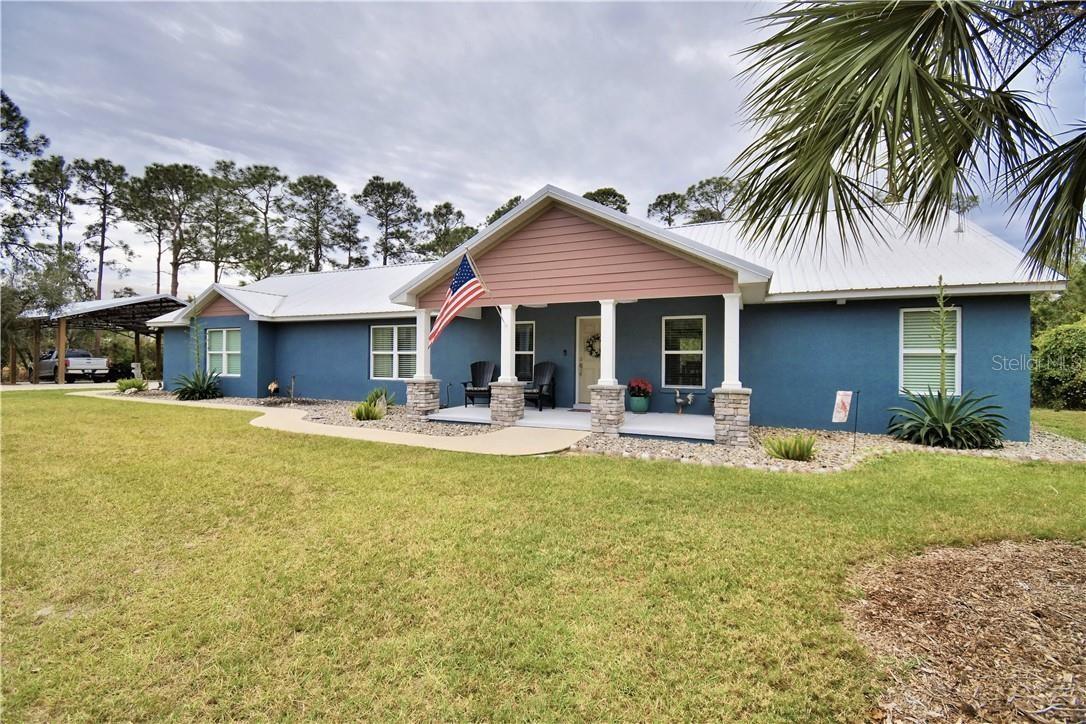 3rd Bedroom an easy option with it's own Mini Split (See plan drawing in attachments). 7.58 acres currently a 2 BR 2 BA home with Lake Reedy Access of beautiful, natural Florida land, abundance of wildlife and access to bass fishing heaven & FAA approved for Seaplanes in Lake Reedy. Unique in so many ways. Horses are allowed according to the HOA but limits. Beautiful landscaping with palms, river rock and ornamentals welcome you to the front entrance. Exterior colors, along with columns accented with stone, draws you to rocking chairs and enjoy the serene natural beauty and sounds of nature. This stunning home offers over 3000 sq. feet under a metal roof. As soon as you enter the home you are greeted by the open perfectly designed floor plan with great room, dining room & amazing kitchen. Kitchen features granite counters that flow up for the back splash, deep sink, soft close drawers, GE stainless appliances, wood cabinetry & nice size island also with granite top. Crown molding accents this great area along with both bedrooms. Color scheme is crisp & bright, the luxury laminate flooring is gorgeous throughout the home. The hall from the kitchen to the garage takes you by the nice sized open shelved pantry & coffee bar & into laundry room where a granite countertop flows above the LG Thin Q washer & dryer making a perfect folding area and continues to and around the laundry sink. The master bedroom offers beautiful lighting and custom Bali blinds, ensuite master bath boasts of tile flooring, a walk in closet with shelving, tall counters with dual sinks and a very large ADA walk in shower with dual shower heads including a rain shower. Adjacent to the master thru French doors is a sunroom with a wall of windows and custom Bali blinds allowing the view of nature at its best and an entrance to the screened lanai. In this split floorplan the 2nd bedroom is like a 2nd master just beyond the living room/kitchen area. Oversized closet, dual access bathroom with large walk in shower, tall counters and granite make this perfect for the ensuite, guests or workshop in garage. The lanai can also be entered thru French doors off the dining room offering the perfect area to enjoy morning coffee or relax at the end of the day. Beyond the lanai a pan roof covers the outdoor kitchen area complete with brick pavers, sink, ceiling fan, gutters and room for a grill. Just steps away from the outdoor kitchen you will be amazed at the large brick paver area where the fire pit awaits. This area is perfect for quiet personal enjoyment or gatherings with friends and venturing down the cleared paths on the property or enjoying fruit from the orange, avocado or grapefruit trees. The garage is over 900 sq ft and designed for 3 cars. It has two garage doors so has plenty of room for golf cart or motorcycles, etc. and work space. Some of the Kobalt cabinets shown are staying as well as a mini split AC unit. The 40 X 30 concrete floor pole barn has electricity and water is nearby as well as a storage shed. Lake Reedy is known as one of the best fishing lakes in this area. This home not only has access to lakefront on Lake Reedy but you also have access to the public boat ramp that is a nice ramp with floating dock, restrooms and not far away. Don't miss out on this one. Schedule your private showing today and make this your forever home. ***These photos show it furnished. It is not furnished any longer***