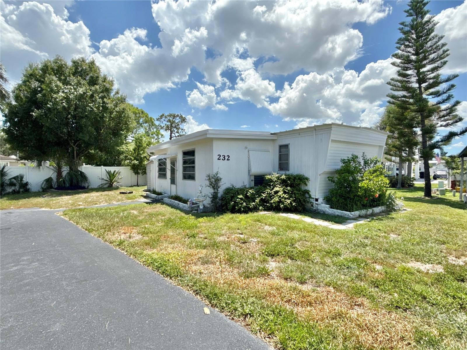 Unique opportunity! This 3 bed/1 bath home is located steps from community private boat ramp and picnic area on large saltwater canal to Tampa Bay with no bridges. Remodel the home that is there or replace with a beautiful modular stilt home that would have peaceful water views! The home sits along the community's perimeter fence on a large lot. Current home has 732 sq feet of living space plus a 200 sq ft enclosed Florida room that can be air conditioned to increase the living space. Nice layout with 3 bedrooms in split plan. Open living/dining/kitchen area and inside laundry with washer and dryer. Original wood paneling brings character! Long paved driveway can hold 3 cars easily. If you've been searching for a quiet retreat that's close to the water, then this is is. Price includes share for the lot and ownership in the community. Furnishings are optional. Home is located in 55+ waterfront community that's only 10 mins to downtown St. Petersburg. Two airports are 15 mins away and the beaches are only 25 mins away. Low monthly maintenance fee of $380 includes water/sewer/trash pick up/lawn mowing/24 hr manned gate/private streets and all amenities, which include heated pool, fitness center, billiards and so much more. This is truly a great opportunity to rehab or build new--buyer's choice. Management requires 675 or above credit score.