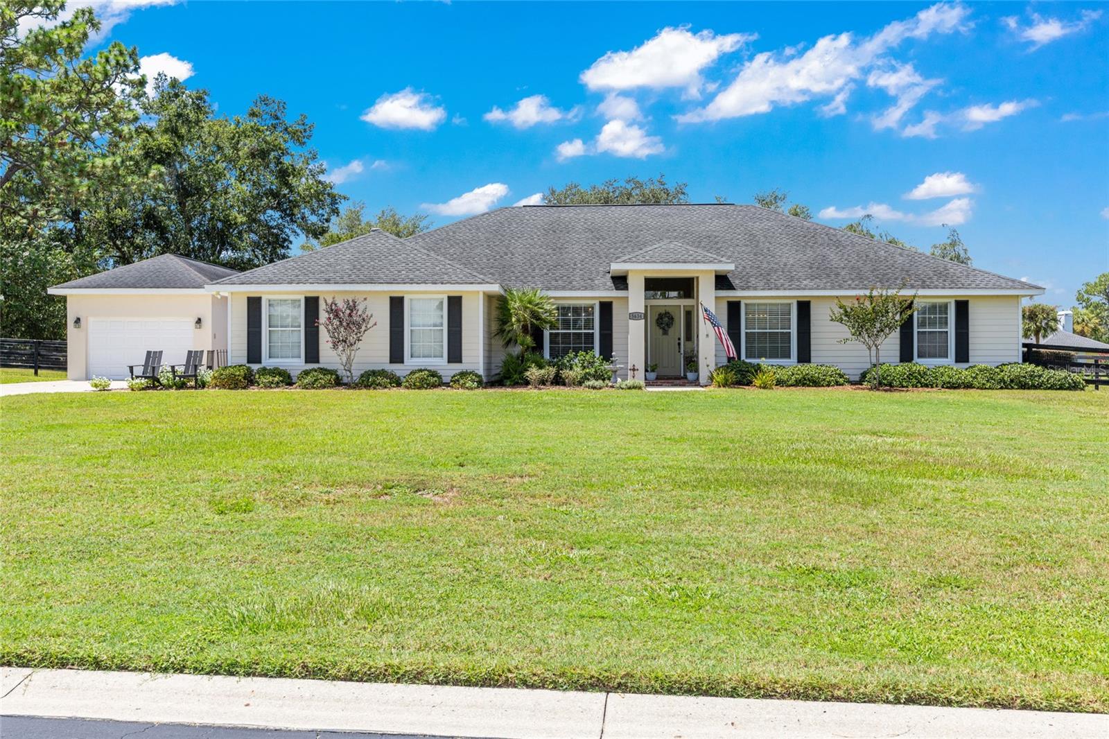 One or more photo(s) has been virtually staged. POOL + DETACHED IN-LAW APARTMENT- Nestled in sought after Silver Meadows Central neighborhood of NE Marion County, this lovely single level ranch-style pool home, built in 1996, with detached In-Law apartment, built in 2003, offers 4 bedrooms and 3.5 bathrooms with 2,925+/- square feet of living space (including In-Law apartment), situated on .70 acres with fenced backyard and heated salt water pool. Lovely curb appeal, with new brick paver porch entry framed by lush Florida landscaping. Step inside the foyer entry to seamless new beautiful wide plank flooring throughout. The vaulted great room features a gas brick fireplace focal point and a formal dining room off foyer entry is perfect for enjoying the seasons and holidays with family and friends. The eat-in kitchen opens to the great room and features an abundance of custom cabinetry with pull outs, built-in home office, a suite of stainless appliances and granite countertops. The primary bedroom offers French door walk-out to covered lanai providing pool access, walk-in closet, en-suite with dual sinks, soaking tub and updated tiled walk-in shower. Additionally, the split floor plan offers two guest bedrooms, a flex room, full pool/guest bath, powder bath, laundry room and two car garage with 30amp hook-up. Outside, enjoy your screened-in pool and summer kitchen, perfect for entertaining year-round. The detached In-law studio apartment includes a private entrance, full bath, kitchenette, and oversized 1-car garage-ideal for guests or extended family. Situated on a spacious lot with mature landscaping and a storage/garden shed. Silver Meadows is a gated neighborhood with a very low HOA offering a quiet country feel with the added comfort of a community. Silver Meadows offers Community Recreation Facilities (Tennis Courts, Racketball, Basketball) and is close to Historic Silver Springs State Park, ALDI, restaurants and shopping.