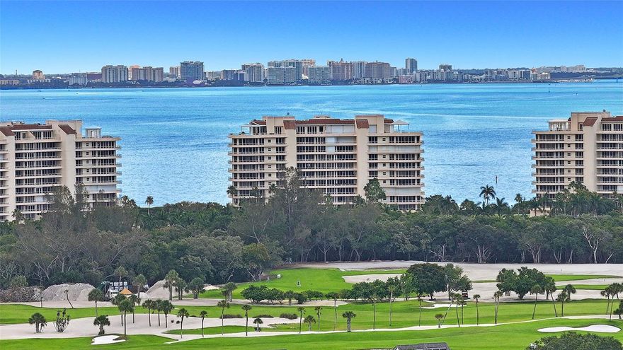 Welcome to a world of luxury and refinement in this 3BR/3.5 BA masterpiece of 2,925+/- sq. ft. in the prestigious Grand Bay community on Longboat Key. From the private elevator lobby, step through the elegant double doors and be captivated by the sumptuous style, with rich wood floors that enhance the stunning blues and greens visible through expansive walls of glass. Positioned on the south side corner of Building 3, this residence offers one of the most spectacular views in all of Grand Bay, offering a visual feast of sunrises over the bay and sunsets beyond the Gulf. Gaze out at the marina from this prime 8th-floor vantage point. The updated kitchen has quartz countertops, top-of-the-line Bosch appliances and an adjacent eat-in area framed by stunning vistas. Each bedroom is a private enclave with its own bathroom en-suite, while the master suite is a lavish escape, featuring access to the open terrace and an opulent master bathroom with a spa tub, glass walk-in shower and a fabulous ceiling light fixture. The voluminous, custom walk-in closet caters to your dressing needs. The crown jewel is the expansive wraparound terrace, an idyllic setting for hosting or unwinding, with the bay’s shimmering waters extending into the horizon. Additional features include two secure parking spaces, electric storm shutters throughout, a beverage bar with wine cooler, a new 5-ton A/C system and a laundry room equipped with newer Whirlpool front load washer and dryer. Residents of Grand Bay enjoy a host of amenities, including a 24-hour guard gate, clubhouse, fitness center, 2 Har-Tru tennis courts, 2 heated pools and a spa. Deeded access to the private beach is close by.