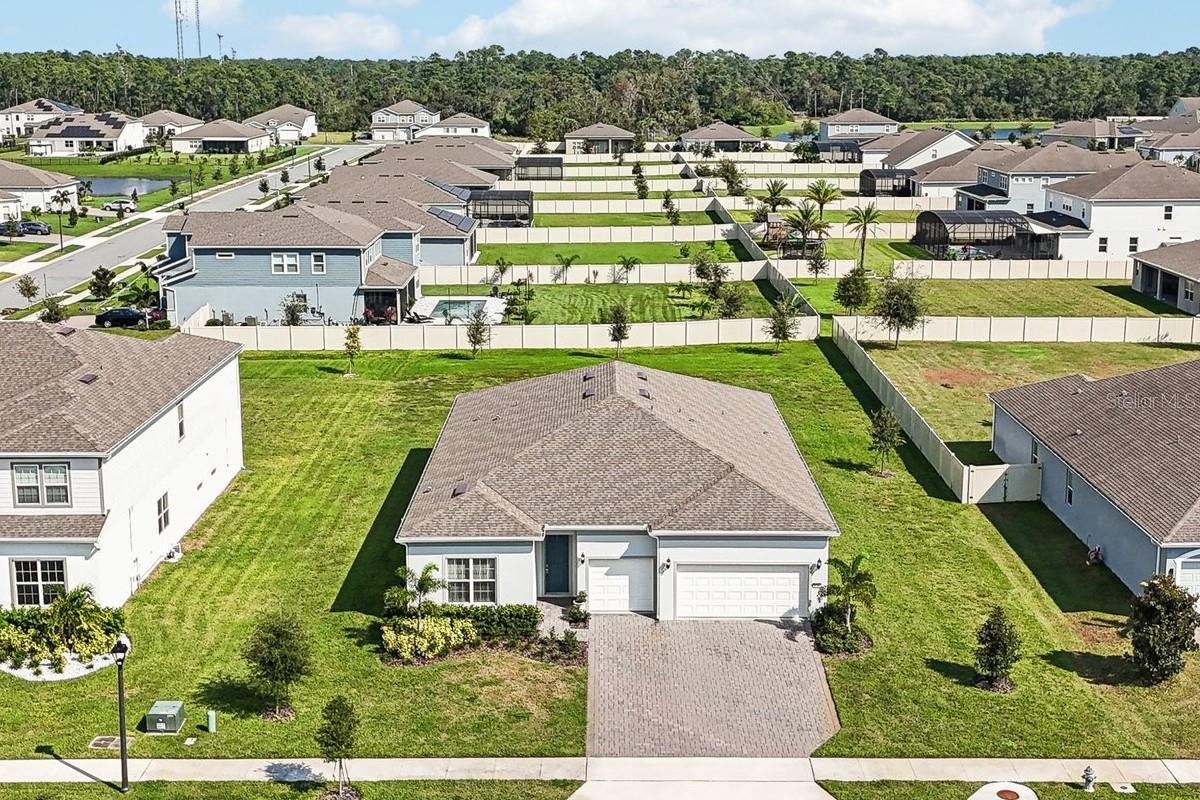 This property qualifies for a CREDIT UP TO $9750 through the seller's preferred lender ~ Looking for a quiet community in the heart of East Orlando with private LAKE ACCESS via a community boat ramp on LAKE PICKETT and easy
access to every convenience? Look no further than Sunset Preserve and this MOVE IN READY / 2023 BUILT home on an oversized HALF ACRE LOT
offering 3-bedrooms + flex space, 3-full baths, a 3-car garage and WATER VIEWS! This light and bright OPEN CONCEPT floor plan has TILE
FLOORS throughout making maintenance a breeze, HIGH CEILINGS, formal and casual dining spaces, a chef’s dream kitchen all in an unbeatable
location. The wall of sliding glass doors off the living area lets the NATURAL LIGHT pour in creating a warm and inviting atmosphere for friends
and family alike. The kitchen is what home chef’s dream about delivering a great mix of cabinet and drawer storage, crown molding, UPGRADED
STAINLESS STEEL APPLIANCES, tiled backsplash, WALK-IN PANTRY and breakfast bar seating on the large ISLAND! Ideal SPLIT BEDROOMS give
the homeowner a true escape in the PRIMARY SUITE where the crown molding continues and the private en-suite bath allows you start and end
your day with ease complete with a large WALK-IN CLOSET. There is a second bedroom at the front of the home with access to a full guest bath
and tucked away on the other side of the home is a third en-suite bedroom perfect for overnight guests or in-laws! Need a home office? This floor
plan offers a generous FLEX SPACE behind double doors versatile to use however you or your family might need. The COVERED PAVER LANAI and
expansive backyard give you the perfect canvas to imagine and create the outdoor space of your dreams and you have VIEWS OF LAKE PICKETT
from the front. The Sunset Preserve community offers an extraordinary lifestyle in a convenient East Orlando location for easy access to SR 417
and 408. Residents will enjoy the GATED ACCESS, open air pavilion, playground and of course private access to freshwater Lake Pickett! Call
today to schedule your tour and let us say WELCOME HOME!