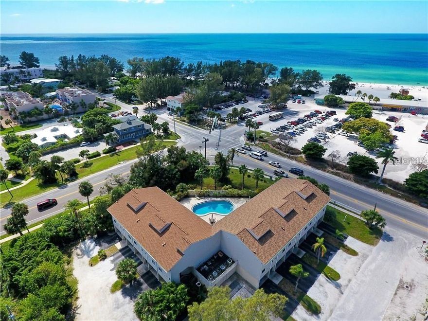 Directly across the street from the beach with Gulf water & beach views. This updated, turn-key furnished unit is centrally located on the island with easy access to the beach, several restaurants and shopping. "Beach Townhouses" is a smaller complex with just 11 units in total offering a large, heated pool, spacious private carports & storage located on the ground level. Each unit offers TWO balconies facing the beach. The one off of the main floor living space is larger & screened. The additional, primary bedroom balcony is covered & open air. Both are a great place to catch the sunset or to enjoy your morning coffee! The master suite offers an updated master bath, dressing area and a walk-in closet. This comfortably furnished unit is being sold turn-key furnished for convenience of a future vacation rental. There are three storage closets in the carport. A smaller, private patio is located pool-side for grilling & al fresco enjoyment. Easy access to the Manatee Bridge to avoid traffic to the mainland during our busier seasons. Want to be right in the heart of A.M.I., schedule a showing today!