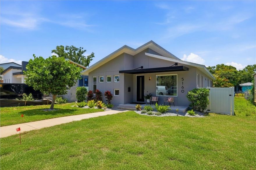 Meticulously constructed by Cornerstone Building Concepts in 2019, this modern 3-bedroom, 2-bathroom home in St. Petersburg delivers a perfect mix of contemporary style, thoughtful upgrades, and effortless low-maintenance living. The open-concept design features soaring ceilings and abundant natural light that create a bright, airy, and welcoming atmosphere throughout.
The heart of the home is the gourmet kitchen, anchored by custom Londos Cabinetry, dramatic quartz waterfall countertops, premium stainless steel appliances, and a large island that seamlessly connects to the dining and living areas—perfect for effortless entertaining and daily living. The primary suite offers a true retreat with a spacious custom California Closet system and a spa-like ensuite bathroom featuring a walk-in shower, dual vanities, and high-end finishes. Every closet in the home is equipped with California Closet systems for superior organization and storage. Step outside to a private patio and fully fenced backyard with low-maintenance landscaping, durable vinyl fencing, and convenient alley access. Standout features include hurricane-impact sliding glass doors, a comprehensive hurricane shutter system, luxury vinyl plank flooring throughout, a generously sized laundry room with custom built-ins and a utility sink, a two-car garage, and smart home touches like a WiFi thermostat and security system. Ideally located in a non-evacuation zone on high ground (no flood insurance required), this home sits just minutes from shopping, dining, and entertainment. It’s roughly 10 minutes from vibrant Downtown St. Pete and 15–20 minutes from the Gulf beaches—offering the ideal blend of convenience and coastal Florida living.