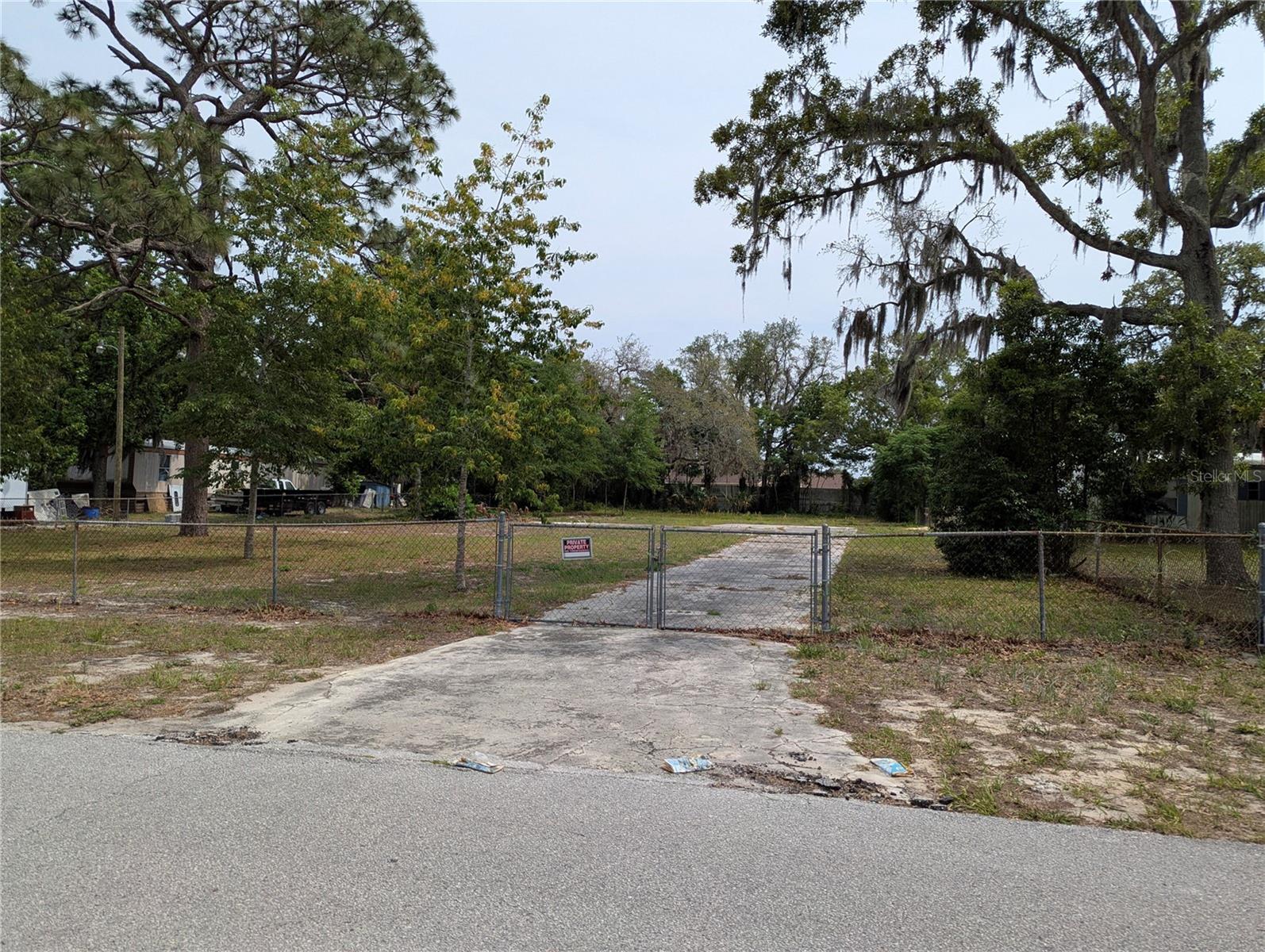 This lot is over 1/2 acre located in central Pasco along a quiet dead-end road and is ready for your home. This fenced-in lot has a septic, water, and driveway "on" site. All you need is the electric pole. The location of this site within Parkwood Acres has low-traffic and provides that private Paradise you've been wanting. BUT it's close to everything such as the Gulf for all your water pleasures and major roads that take you to Florida's abundant destinations. CALL NOW!