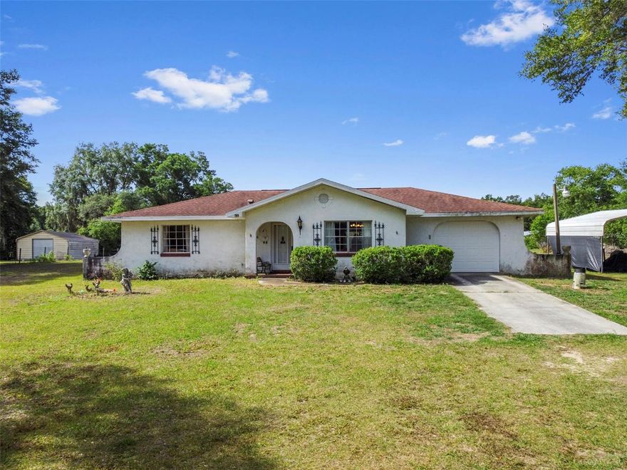 This 2-bedroom, 2-bath block home sits on 2.4 acres and comes with the updates that matter most — roof (2018), solar panels, and a newer A/C. The property is fully fenced and mostly cleared, with a Covered 2-stall setup ready for your horse, plus a one-car garage for extra storage or workspace and 2 sheds.
Inside, it’s definitely giving “vintage.” Not the trendy kind — the “you can make it exactly what you want” kind. It could use some fresh paint, fresh air, and a little love, but that’s where the opportunity is. You’re not paying for someone else’s updates — you get to create your own.