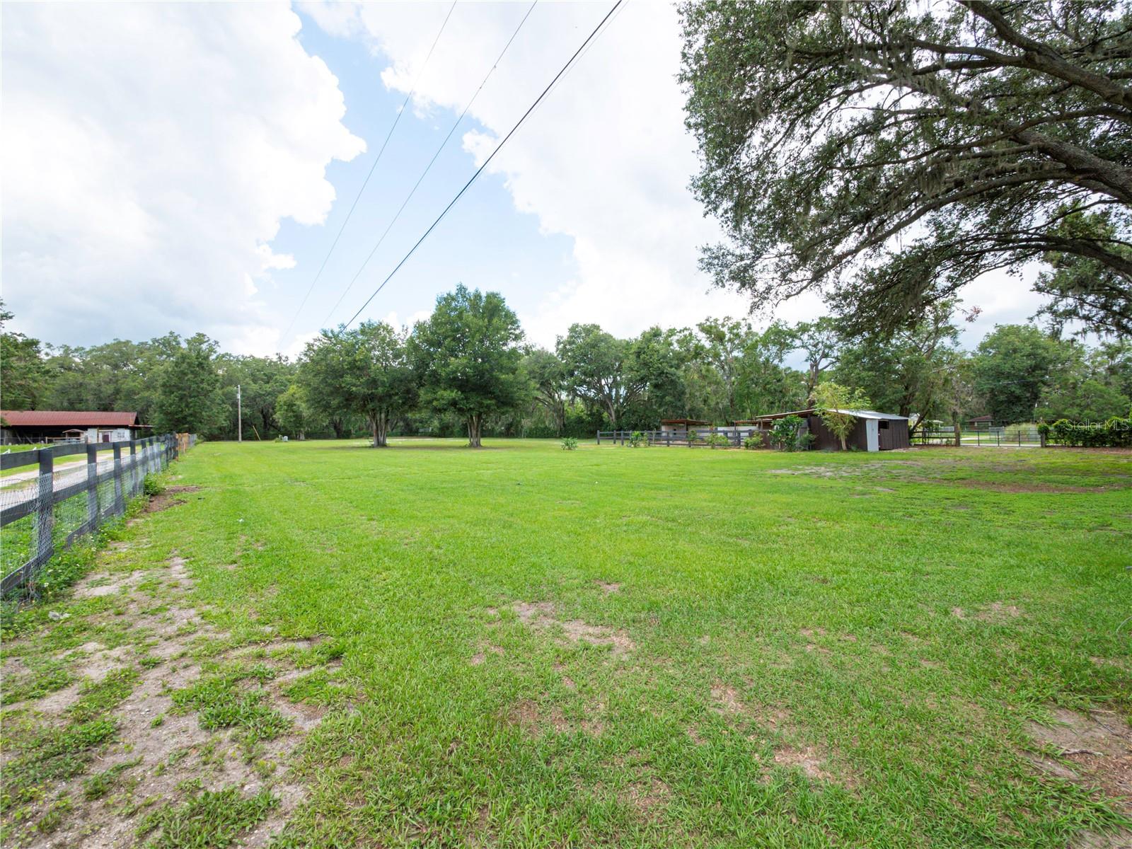 Under contract-accepting backup offers. Looking for a nice sized property? Ready to build your custom home? Looking for Country Living! Check out this beautiful Vacant Land FOR SALE! This beautiful 1.66 acres of buildable Land with Endless Potential is available! Located in a quiet neighborhood with water, well, and power already in place with the property's perimeter completely fenced with 2 gated entries. This land includes a horse barn, is cleared and clean, is not located in a flood zone, and there are no deed restrictions or HOA. This is a wonderful place to call home; a great place to relax and escape the hectic pace of life. Located in the country in North Lakeland, this land is in a convenient location, close to shopping, dining, and only minutes away from I-4 for easy access to Tampa/Orlando.
We welcome you to come by and take a look at your future land!
*Note: The home located in front of the vacant land will be listed separately.