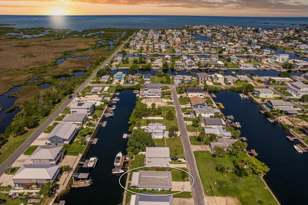 One or more photo(s) has been virtually staged. ADORABLE & AFFORDABLE Waterfront Bungalow in the Coastal Community of Hernando Beach. Direct Access to the GULF - No Lifts.. No Bridges.. Minutes to the Open Gulf Yet Tucked In.. Fully Renovated 2 Bedroom 2 Bathroom Oversized 1 Car Garage. PERFECT VACATION HOME.. Come See this OPEN Floor Plan with a Beautiful Coastal Kitchen, Great Room and a Sitting Area. Large 31x12 Back Porch right off the Great Room & Sitting Room. Home has Tiled Plank Flooring Through Out. Back to the Kitchen... So Very Pretty.. Island Breakfast Bar with Pendent Lighting, Quartz Countertops, White Soft Close Shaker Cabinets, Stainless Steel Appliances & Aqua Subway Backsplash. Just Love that Color. Primary Suite is Separate from the Guest Bedroom & Offers a Large Walk In Closet plus Brand New Remodeled Bathroom. Guest Bathroom is also New. New Hot Water Heater & 2015 HVAC unit & 2005 Three Dimensional Shingled Roof. Hernando Beach is a Quaint Coastal Community that offers a Fun Boating Lifestyle... Fishing, Playing with Your Jet Skis, Hanging out at the Local Flats, Sunset Cruises.. Enjoying Kayaking, Paddle Boarding in the Canals.. Restaurants, Coffee Shop, Marinas, Gift Shops, Art Shows, Festivals.. Plus Lakes with Trails at the Preserve on the East Side of Shoal Line Blvd.. Or Down the Road & Coast is the Weeki Wachee River.. So Much to Do.. SHORT TERM RENTALS Are Allowed! Truly a Change of Lifestyle...