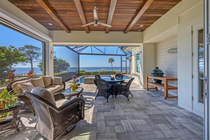 “Coastal Elegance on Sarasota Bay” Discover unparalleled coastal living with this custom 3,000 square foot Waterfront home with 20,000 sf of land and 100 ft of Sarasota Bay frontage offering one of the most incredible 180-degree views of the Bay. Built in 2019, to highest wind code standards this one story Coastal Architectural-Style gem blends modern luxury with timeless charm, offering 4 spacious bedrooms and 4 ½ beautifully designed bathrooms. Due to a home site elevation at 14 ft flood Insurance is optional. One of the few Sarasota Bayfront communities that experienced No Flooding during the 2024 Hurricane Season. Step inside to experience an open and airy floor plan, accentuated by lofty t & g Cypress ceilings and expansive impact windows that frame breathtaking bay views. The living area flows seamlessly into a gourmet kitchen, featuring top-of-the-line appliances, custom cabinetry, and a large island perfect for both casual dining and entertainment, The primary suite is a luxurious retreat overlooking the water featuring his and her separate bathrooms and walk in closets. Each additional bedroom is oversized, ensuring comfort and privacy for family and guests. This home is built for outdoor living, offering a roomy, screened lanai with a heated pool and spa, plus a dining area that is perfect for taking in Sarasota’s sunsets. A private dock and boat lift for easy access to the bay for boating and water activities with no bridges to the Gulf. Additional features include an oversized 3 car garage, 7,500 lb boat lift, whole house backup generator offering peace of mind and added convenience. Located in sought after West of Trail Historic Ballentine Manor within proximity to Colleges, the IMG Academy, SRQ Airport, fine dining, shopping, and cultural attractions. This coastal retreat offers both luxury and practicality. Voluntary HOA $35/Year offers Culinary Membership to Historic Sara Bay Country Club. Do not miss your chance to own this exceptional Sarasota Bay Waterfront Home. Schedule your private tour today and experience the epitome of coastal elegance!