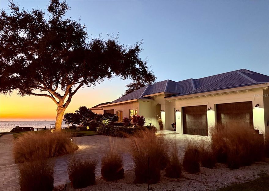 “Coastal Elegance on Sarasota Bay” Discover unparalleled coastal living with this custom 3,000 square foot Waterfront home with over 20,000 sf of land and one of the most incredible 180-degree views of Sarasota Bay. Built in 2019, to highest wind code standards this one story Coastal Architectural-Style gem blends modern luxury with timeless charm, offering 4 spacious bedrooms and 4 ½ beautifully designed bathrooms. Due to a home site elevation at 14 ft flood Insurance is optional. One of the few Sarasota Bayfront communities that experienced No Flooding during the 2024 Hurricane Season. Great potential for vacation rental. Step inside to experience an open and airy floor plan, accentuated by lofty t & g Cypress ceilings and expansive impact windows that frame breathtaking bay views. The living area flows seamlessly into a gourmet kitchen, featuring top-of-the-line appliances, custom cabinetry, and a large island perfect for both casual dining and entertainment, The primary suite is a luxurious retreat overlooking the water featuring his and her separate bathrooms and walk in closets. Each additional bedroom is oversized, ensuring comfort and privacy for family and guests. This home is built for outdoor living, offering a roomy, screened lanai with a heated pool and spa, plus a dining area that is perfect for taking in Sarasota’s sunsets. A private dock and boat lift for easy access to the bay for boating and water activities with no bridges to the Gulf. Additional features include an oversized 3 car garage, 7,500 lb boat lift, whole house backup generator offering peace of mind and added convenience. Located in sought after West of Trail Historic Ballentine Manor within proximity to Colleges, the IMG Academy, SRQ Airport, fine dining, shopping, and cultural attractions. This coastal retreat offers both luxury and practicality. Voluntary HOA $35/Year offers Culinary Membership to Historic Sara Bay Country Club. Do not miss your chance to own this exceptional Sarasota Bay Waterfront Home. Schedule your private tour today and experience the epitome of coastal elegance!