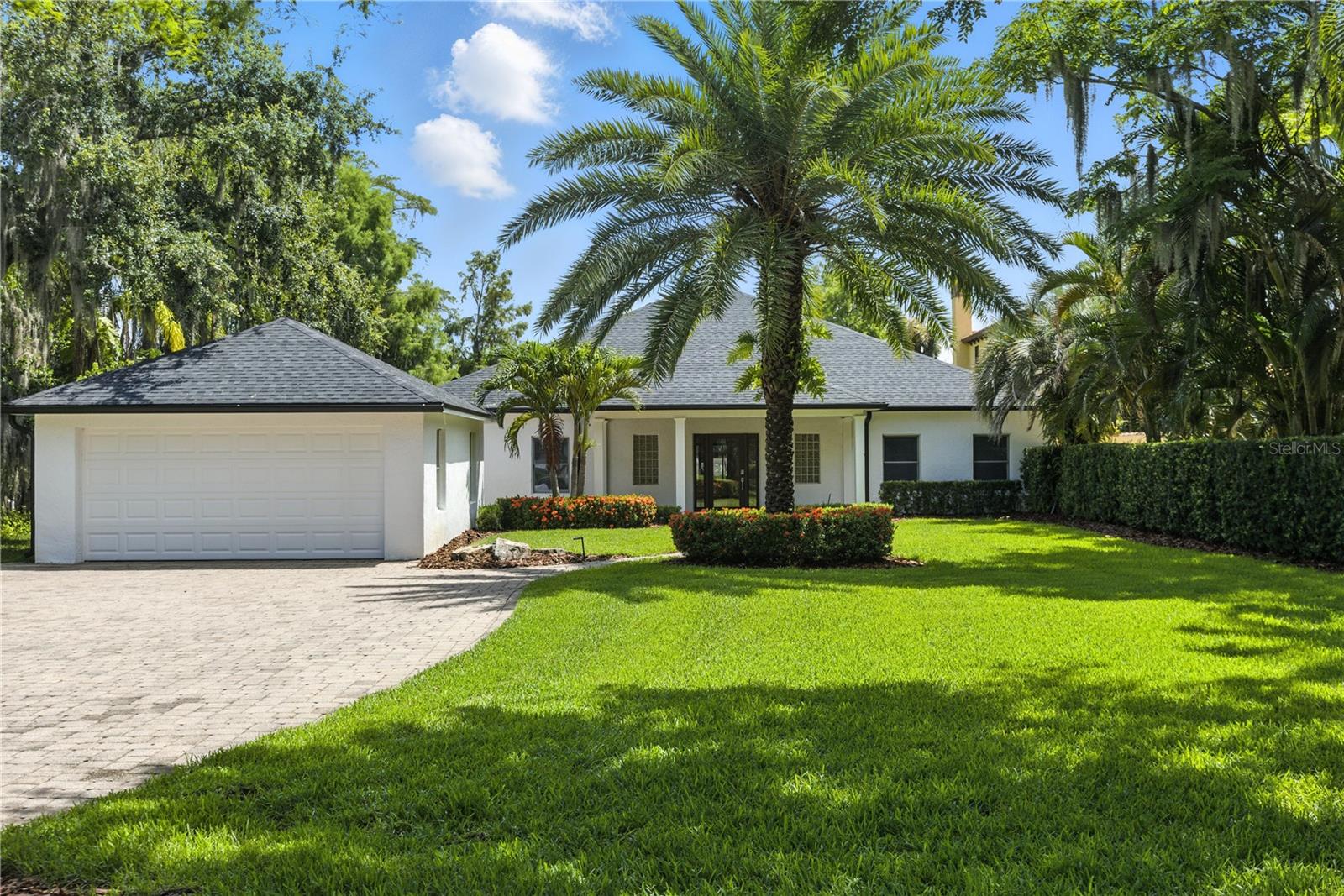CHARMING COTTAGE ON THE BUTLER CHAIN of Lakes! This property features just under 3000 sq ft, 3 bedrooms, 2 1/2 baths and a STUNNING 100 FEET OF LAKEFRONT ON LAKE TIBET located in the coveted BUTLER CHAIN OF LAKES in Windermere/Orlando and NO HOA! LOCATED IN ORLANDO, but less than a MINUTE drive TO WINDERMERE AND within 10 minutes to downtown Windermere and ALL of the charm and activities IT HAS TO OFFER. Completely remodeled from top to bottom in recent years, it's ready to move in! The views start the moment you start walking down the meandering path to the front door as you look through the glass and see the gorgeous lake views, which only get better as you walk into the home. The generously sized foyer will greet your guests as you walk past the dining area and into the huge living space that has a wall of windows and French doors to allow the stunning views of the lake to frame your living space. This large gathering space has beautiful, newly re-finished wood floors that you will love! Through the French doors, your air-conditioned Florida family room with a wall of windows and wood paneled ceiling is the perfect place to gather overlooking the dock and then lake. This home boasts a spacious kitchen complete with new cooktop, double ovens, solid wood cabinetry, granite, and even a butcher block prep station. There is also a beautiful breakfast nook area with banquette and an amply sized walk-in pantry. The large laundry/mud room off the kitchen provides storage and a separate entrance from the garage or front porch! The tucked away, primary suite will not disappoint with its own covered lanai overlooking the lake to spend morning sipping coffee or evening with a glass of wine, a functional bathroom with soaking tub/separate shower, walk in closet as well as a wall of closets. The secondary bedrooms both have custom closets, one with a walk in, and both have low maintenance luxury vinyl plank flooring. The full guest bathroom is right off both of them and the half bath is located off the foyer. It's just under 2 acres of pristine Florida land complete with landscaping that has all been professionally redone in the last few years. The cedar fence down both sides, provides some privacy and adds to the beauty of the yard. Reconditioned in 2018 and 2024, the covered dock has low maintenance composite decking, a raised boat lift and 2 raised jet ski lifts and extends close to 100 ft into Lake Tibet for fishing off the dock or just soaking in the sun and views. Just imagine yourself living the lake life right outside your door. The roof was replaced in 2022 as well as new gutters, re-built seawall, and the exterior has been completely repainted. There is a detached, 2-car garage that you can access from the mud room and a covered breezeway protects you from the elements. The inviting front porch is the perfect place to look out onto the gorgeous front yard, which sits well off of the road. There is also another area for outside entertaining between the breezeway and front porch, there is so much outdoor living in this home! Call today for your private showing of the wonderful lakefront oasis!
