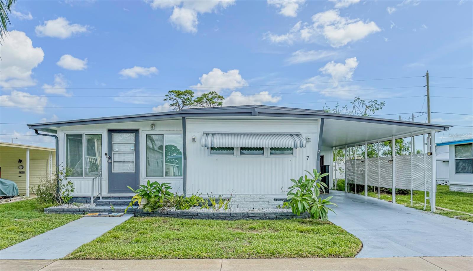 Welcome to Tarpon Shores – a premier 55+ resident-owned, NO PETS community in beautiful Tarpon Springs! This 2-bedroom, 2-bath home offers a spacious enclosed Florida room, a large utility/storage workshop, and a covered carport. Interior features include easy-care vinyl flooring throughout and a durable metal roof for peace of mind.
Low monthly fees include lawn care, water, sewer, trash, basic cable, and access to resort-style amenities: clubhouse, billiards room, heated pool, covered shuffleboard, bocce ball, pickleball, library, and more. Conveniently located just 2 miles from the world-famous Sponge Docks, shopping, dining, golf, beaches, and medical facilities. Experience affordable Gulf Coast living at its best!