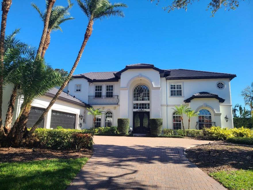 Paradise awaits with resort-style living at its finest. You will love this gorgeous custom-built Mediterranean-style home with pool, spa, separate threita guest house and views of the 11th hole of Robert Trent Jone’s masterfully designed Fox Hollow Golf Course. All this and much more in Floresta, a privately gated section of the desirable Champion’s Club. Upon entering this beautiful home, you appreciate the grand entrance and foyer with soaring ceilings, hand-carved moldings and detailed trim work throughout the house. As you walk on the fabulous marble floors you will gaze upon the lovely, curved iron and wood staircase and recognize the elegance of every fine detail. With over 4,511 square feet of well-designed living space in the main home, you’ll enjoy the formal living room with French doors to the lanai and wonderful views overlooking the pool and golf course. The spacious formal dining room is ready to entertain large or intimate formal dining experience. The gourmet custom kitchen is equipped with solid surface quartz countertops and a beautiful granite sink with ample storage, you cannot help noticing the commercial grade oversized stainless steel KitchenAid refrigerator freezer, the  JennAir w/ four gas burner cooktops, a double indoor grill w/vent, two Frigidaire Electrolux convection ovens, separate warming drawer, Bosch dishwasher and microwave oven. Between the breakfast bar and family room behind paneled French doors is the billiards room, or a fifth bedroom/bonus room with a full wall of storage space. Your family room is warm and inviting to enjoy the fireplace, read a book or watch a sporting event and is adjacent to the breakfast nook and coffee Bar. Continuing to another set of French doors to a paver oasis includes the swimming pool and spa, custom-built outdoor kitchen w/an oversized Viking gas grill, refrigerator, guest bar w/wet bar, disposal, ice maker and gas fireplace with seating areas under cover. The great room has sweeping views of the golf course and additionally on the first floor is a private office and lovely guest bedroom with en suite. The second floor has treasures in every direction with two sizeable guest bedrooms, a shared en suite w/Jacuzzi tub and the loft leads to a large balcony with slate tiling and overlooks your stunning backyard. The primary bedroom is beautiful with a sitting area, tray ceiling and ample size to accommodate your favorite bedroom showpieces. Designer shelving in the walk-in closet is a delight offering added space as your private changing room. The primary bath is complete with a Jacuzzi Garden bath, separate shower, custom walk-in closets and dual vanities. The separate guest house is a fabulous design and a unique casita with a beautiful family room with golf course views, a large bedroom, large closet, full bath with Jacuzzi tub, complete kitchen with electric range cooktop, oven, microwave, pantry, plenty of kitchen cabinets, double stainless sink, granite countertops and breakfast bar.  The side entry three-car garage has floor to ceiling, wall to wall custom storage. The spacious yard is fully fenced with lush tropical landscaping and a gate out to the golf course. Recent home improvements include landscaping, newer air conditioning in one section of home, aluminum fencing, pool motor & pump, painting and staining the exterior front, 2023 XL water softener and marble floor cleaning.  Call today to see this beautiful home!