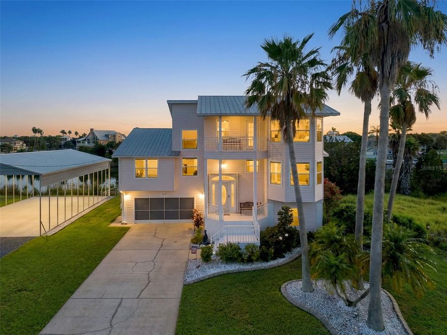 Double lot, RV Port and spectacular view of the Gulf from the upstairs porch. Welcome to your waterfront retreat in Hernando Beach! This maticulously maintained 3-bedroom, 2-bath home is packed with upgrades and sits on a rare double lot totaling 1/3 acre. Bring your Boats and RV — the brand-new spacious 30'x45' reinforced RV/Boat port (2024) is ready for all your toys! A true highlight of the property is the nearly 2,000 square feet of basement/garage space — spacious enough to fit four vehicles plus recreational toys, and still have plenty of room for a large workshop. It even includes a convenient half bath for added flexibility. Inside, you'll find a bright and inviting interior with an open living area, vaulted ceilings, remodeled kitchen and bathrooms, custom 5 inch baseboards, wood valances and new laminate. In the bathrooms, tile showers, guartz countertops, and new vanities and sinks. The kitchen features quartz, a walk-in pantry, undermount lighting, stainless steel appliances and a breakfast bar. Enjoy peace of mind with a metal roof upgraded and reinforced in 2022, 2022 HVAC, 2022 irrigation system, and a 2021 hot water heater. Additional upgrades include Anderson triple-pane impact storm windows (2013), a hidden safe, a security system, and full-house generator wiring (Generac XT8000E generator negotiable). Outdoor spaces are designed for relaxation, with a screened lanai overlooking the canal, dock, a third story porch swing perfect for sunset views, and a fenced yard with room to roam. The versatile loft upstairs offers great flexibility — use it as an office, guest room, or enclose it for a 4th bedroom. With space, style, storage, and waterfront living, this move-in-ready gem with a direct panoramic view of the Gulf is the total package! Preferred lender giving a sizable credit.