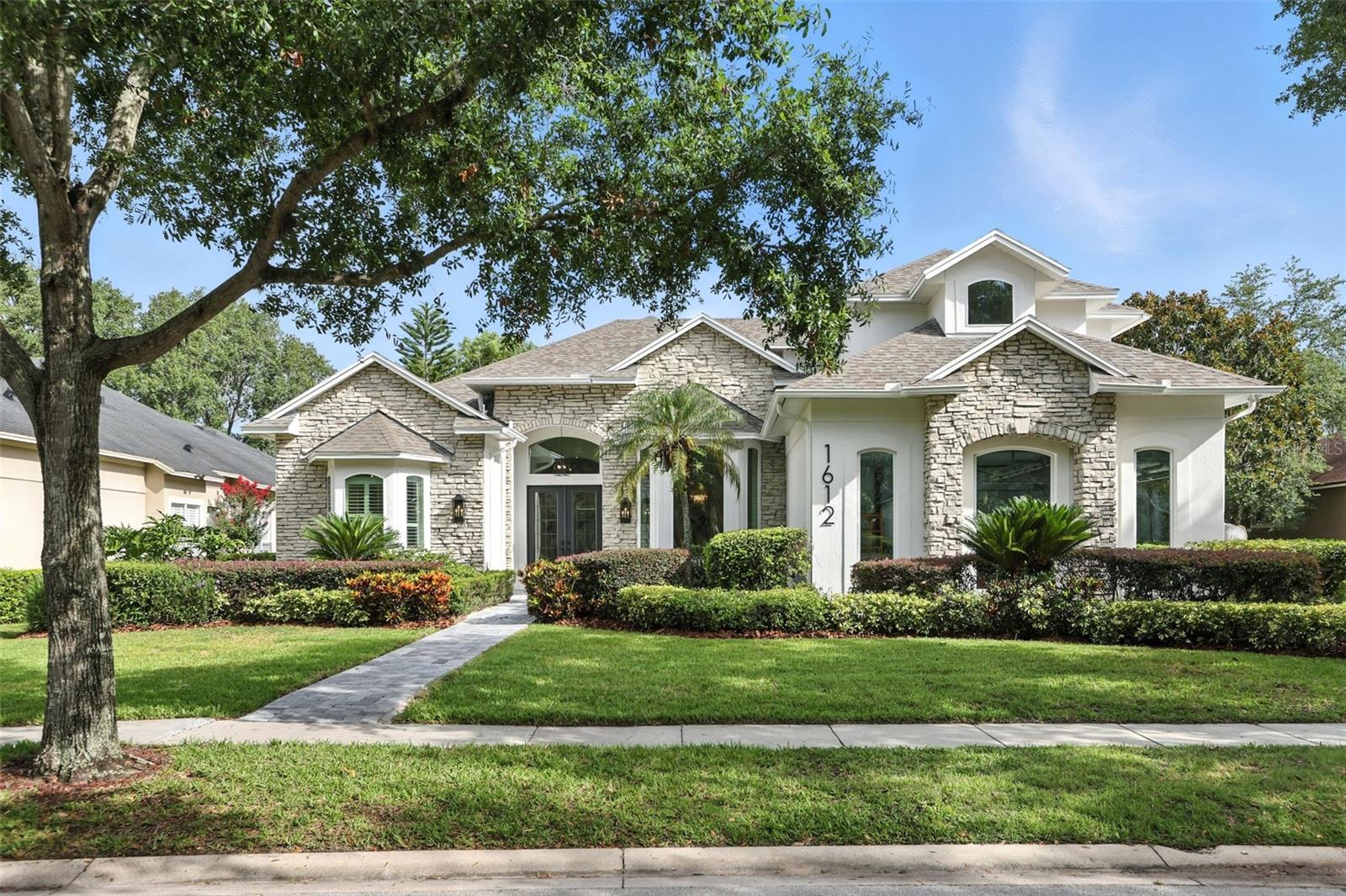 Welcome to 1612 Kersley Circle—a masterfully reimagined sanctuary where architectural elegance meets modern luxury in the renowned Heathrow community. This exceptional 4-bedroom, 4 bathroom split-plan residence, spanning nearly 4,000 square feet, has been transformed into a breathtaking showcase of refined living. Step into a world where natural light dances through custom-crafted, energy-efficient windows throughout a thoughtfully designed living space. Soaring high ceilings create an atmosphere of grandeur, while the open-concept layout flows seamlessly from the oversized dining room to the heart of the home. Prepare to be captivated by the D'Nook-designed gourmet kitchen—a culinary artist's dream featuring custom soft-close cabinetry stretching floor to ceiling, handcrafted venetian plastered hood that whispers sophistication, premium Thermador & Bosch appliances for the discerning chef, Stunning dolomite countertops with dramatic waterfall edges, a thoughtfully integrated coffee station for morning rituals and an expansive walk-in pantry that redefines storage elegance. The spacious living area beckons with its striking modernized fireplace and custom stone finishes, creating the perfect backdrop for both intimate conversations and grand entertaining. Custom millwork and contemporary materials throughout establish a warm yet refined ambiance that speaks to the most discerning tastes. Escape to the luxurious owner's suite—a sprawling 600 square feet of pure indulgence featuring dual walk-in closets and independent vanities. The spa-inspired bathroom, complete with a freestanding soaking tub and glamorous finishes, transforms daily routines into moments of pure relaxation. This thoughtfully designed home offers exceptional flexibility with two additional first-floor bedrooms sharing an elegant jack-and-jill bathroom, plus an additional private suite upstairs. The expansive bonus room and dedicated office space provide endless possibilities — perfect for multi-generational living, creative pursuits, in-law suite, or professional endeavors. Step onto your private back porch and discover your own resort-style escape. The recently renovated heated pool with a stunning mosaic finish and adjoining bathroom creates the perfect setting for peaceful evening reflections or lively weekend gatherings. Every detail has been meticulously updated for the discerning homeowner. Newer roof (2022), dual AC systems (2025), Custom windows (2025), Elegant pavers (2025), new smart water heater (2025) , Pool Pump (2025) , Pool Heater (Ordered) and plantation shutters. Embrace the exclusivity of 24-hour manned gate security while enjoying access to community parks, playgrounds, and optional country club memberships featuring golf, tennis, fitness facilities, and a resort-style pool. With convenient access to I-4, 417, and the Wekiva Parkway, you'll enjoy the perfect balance of serene luxury and urban connectivity.