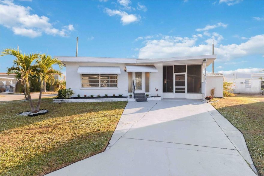 One or more photo(s) has been virtually staged. Welcome to Tidevue Estates, a sought-after 55+ land-owned community offering an active Florida lifestyle in a charming, well-maintained setting. This inviting corner-lot home is framed by mature Christmas palms and native landscaping, creating a welcoming first impression. The perfect space to relax, unwind, and enjoy the neighborhood atmosphere.

New Roof in 2024 for peace of mind. Inside, the home features a bright, open living area highlighted by a solid wood shiplap accent wall and decorative wall sconces that add warmth and character. The cozy kitchen is well equipped with an oven range and durable laminate flooring, ideal for everyday living. The owner’s bedroom has been thoughtfully updated with beadboard walls, three closets, and a built-in dresser for ample storage.

A spacious 16x16 Florida Room with solid wood beams, adding approximately 256 square feet of additional living space. The inside laundry room includes a wall A/C unit that also services the Florida Room.

Residents of Tidevue Estates enjoy a low HOA of only $600 annually, free Wi-Fi at the community library, and an impressive array of amenities including a heated community pool, fitness center, pickleball, bocce ball, shuffleboard, and a full calendar of social activities. Just a short bike or golf cart ride away, Veteran’s Park offers peaceful nature views, picnic areas, and stunning sunsets.

Conveniently located near I-75, Ellenton Premium Outlets, dining, and medical facilities, with easy access to Sarasota, UTC Mall, St. Armands Circle, Selby Botanical Gardens, the Ringling Museum, and the Gulf’s beautiful beaches. Come experience the Tidevue lifestyle.