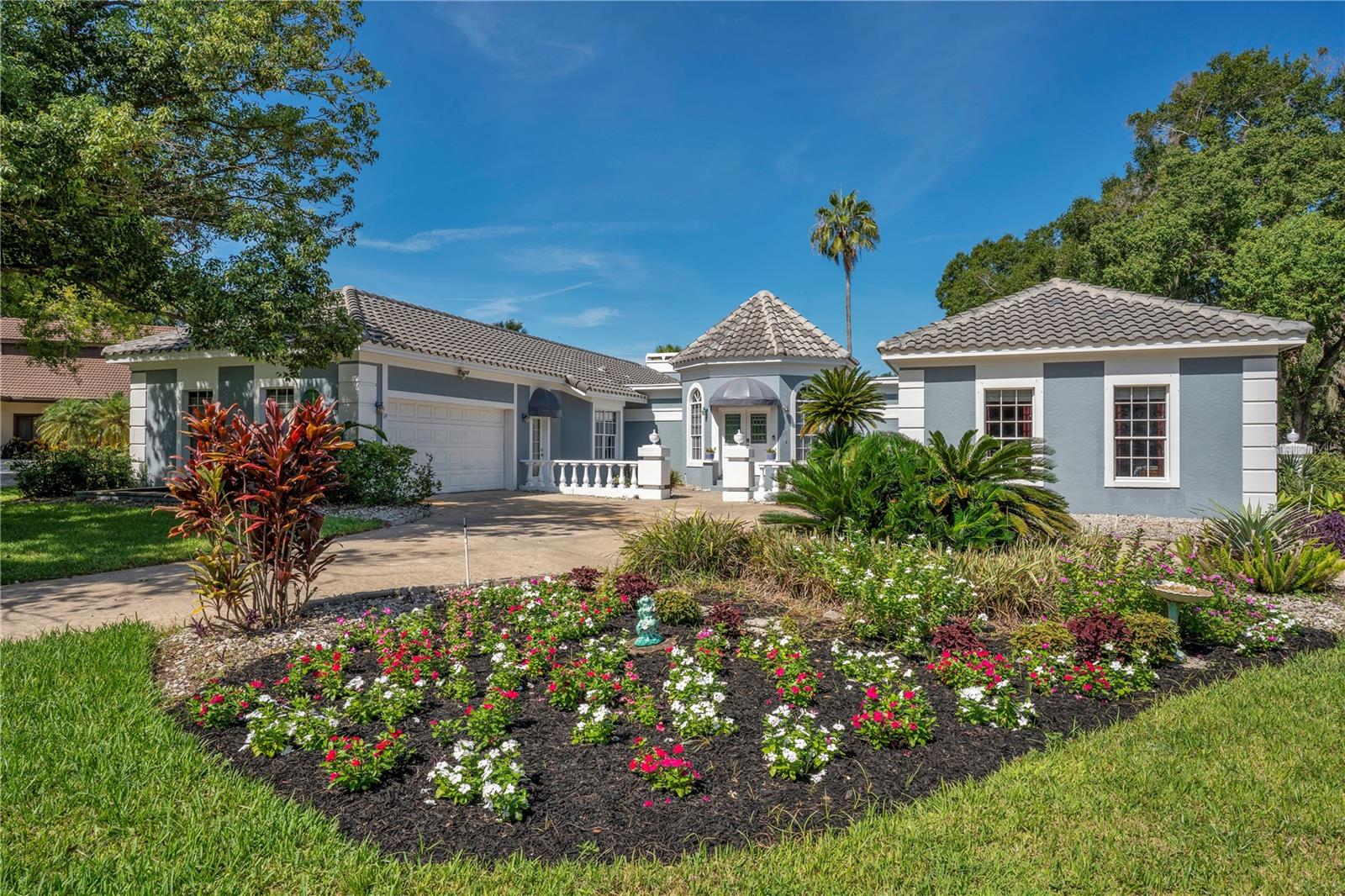 Welcome to this beautifully updated single-story pool home, tucked away on a private cul-de-sac in the desirable South Bay community—just a golf cart ride to the famed Bay Hill Golf Club.
Set on nearly half an acre with peaceful water views right out the front door, this 3-bedroom, 2.5-bath residence offers over 3,190 sq. ft. of open, elegant living space. A circular driveway adds to the home’s curb appeal, complementing its unique design and inviting presence.
Step inside to a grand foyer with a statement chandelier and porcelain "marble look" tile flooring, setting the tone for the home’s refined style. The unique split floor plan provides versatile living options, including large bedrooms connected by Jack-and-Jill bathrooms for convenience and privacy. The freshly painted family room offers a bright and welcoming gathering space, while upgraded finishes add a touch of luxury throughout.
The kitchen features rich upgraded cabinetry, stainless steel appliances, and gorgeous quartz and soap stone countertops. It flows seamlessly into a spacious formal dining and living area anchored by a wood-burning fireplace—perfect for entertaining.
The primary suite boasts bamboo floors, a walk-in closet, and a spa-inspired bath with travertine, a clawfoot tub, and premium finishes. Wood-look tile extends through the kitchen and main living areas, complementing the home’s light-filled, oversized rooms designed for both comfort and function.
Step into your private backyard retreat with a large swimming pool, freshly painted sundeck, storage shed, and an expansive yard offering both space and seclusion.
South Bay residents enjoy exclusive amenities including tennis courts, walking trails, a community playground, and a private dock on the Butler Chain of Lakes, plus year-round neighborhood events. Zoned for A-rated Dr. Phillips schools and just minutes from Restaurant Row, world-class golf, multiple theme parks, and major highways, this home delivers the perfect blend of luxury, lifestyle, and convenience.
