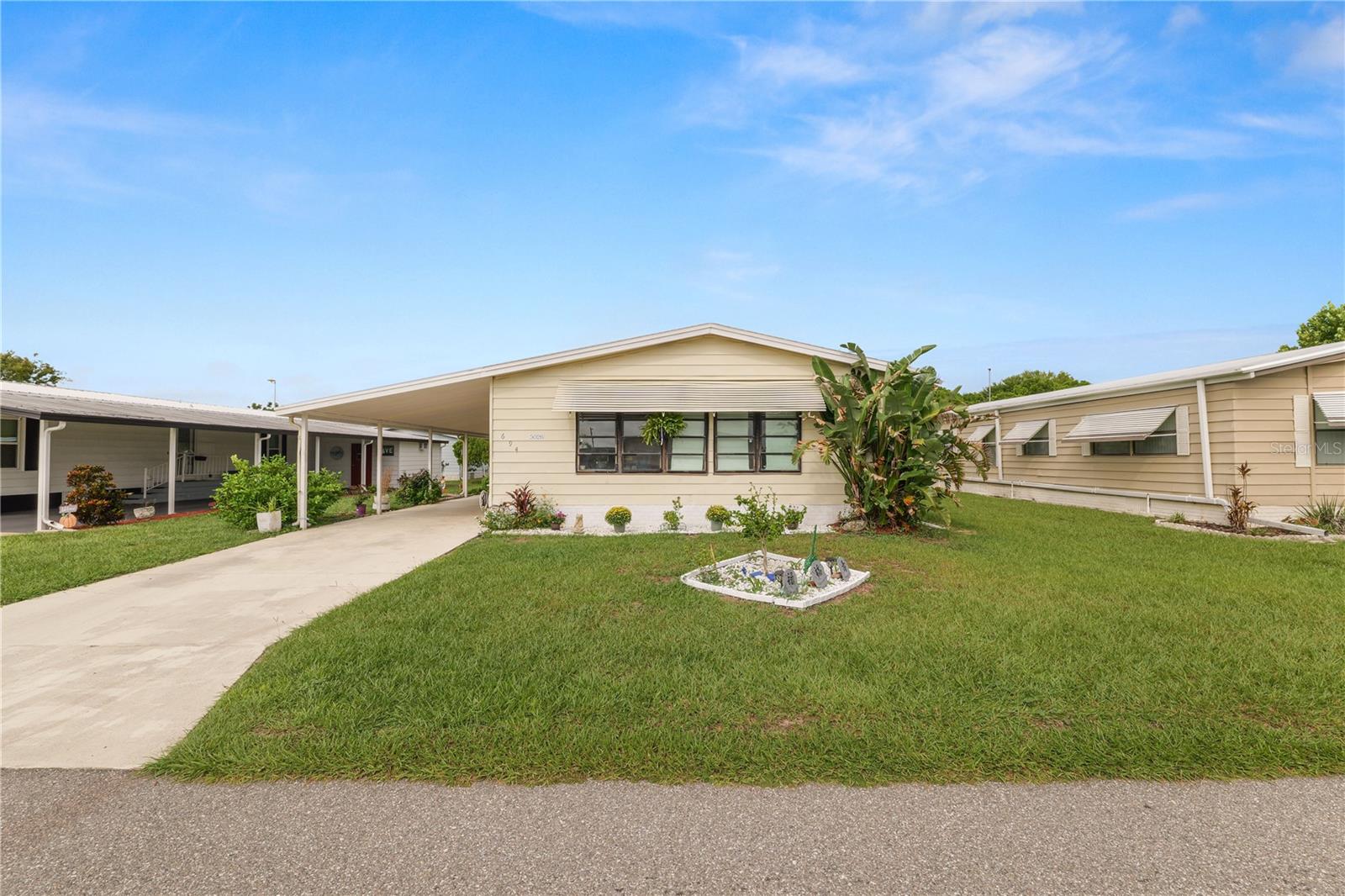 Welcome to your 2 bedroom 2 bathroom home located in the vibrant 55+ community of Foxwood Lake Estates. This home features a spacious living room with built-ins. The kitchen/dining room offers plenty of space for entertaining friends and family. Laminate flooring runs throughout the home, while the entertaining Florida room is carpeted. The primary bedroom is spacious and offers two closets along with an en-suite with a single sink vanity and walk in shower. The 2nd bedroom offers a walk-in closet and generous space and natural lighting. The laundry hook ups are located in the outdoor, oversized storage room. The community offers a clubhouse, pool, shuffleboard courts and many more amenities! Schedule your private showing today!