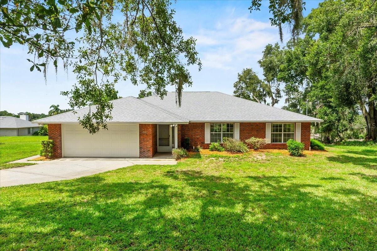 Tucked away on a quiet dead-end street in Haines City, this beautiful 3 bedroom, 2 bath home sits on over a third of an acre and offers the perfect blend of privacy, space, and comfort. With a brand new roof (2025) and a thoughtful layout, this home is ideal for both relaxing and entertaining.
Inside, you'll find an open floor plan with split bedrooms, a formal living and dining room for hosting special occasions, and a separate family room that’s perfect for everyday living.
The spacious kitchen is equipped with ample counter and cabinet space, a stainless steel appliance package, and an adjacent dinette for casual meals. The dinette offers a closet pantry and a laundry closet that comes fully equipped with a washer and dryer, adding to the home’s convenience.
The primary suite is generously sized with two large walk-in closets and a private en-suite bath featuring dual sinks, a water closet, and a handicap-accessible tiled shower. The two additional bedrooms are located on the opposite side of the home, offering privacy for guests or family members, and are served by a well-appointed guest bath with a tub.
Step outside to the huge 32' long screened lanai, the perfect place to enjoy your morning coffee or unwind in the evening while overlooking the peaceful backyard. Surrounded by mature trees and located near Lake Eva, this serene setting offers a true sense of retreat while remaining within 10 minutes of shopping, dining, medical facilities, schools and the Lake Eva Event Center. Also, centrally located between Tampa and Orlando.
Additional features include a foyer coat closet, a security system, an irrigation system with a separate water meter, and vinyl fencing in the backyard—adding value, privacy, and convenience to this already impressive home.
Homes like this—spacious, full of character and in a great location—don’t come around often. Schedule your private showing today before it's gone!