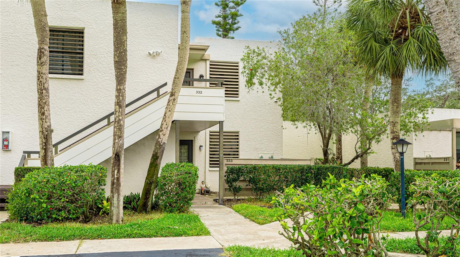 Experience the beauty of Old Florida at Wildewood Springs, a modernist-designed condominium community set within an 88-acre Audubon bird and wildlife sanctuary. Surrounded by lush palm trees, majestic live oaks, vibrant flowering trees, and serene lakes, this peaceful retreat offers a true connection to nature. Residents enjoy walking, jogging, and biking through the tranquil grounds, along with access to multiple swimming pools, tennis courts, and pickleball courts.
This spacious 2 bed 2 bath 1,408 sq. ft. condo (plus an expansive 25' x 9' screened lanai overlooking the pool and lush greenery) provides the perfect blend of indoor and outdoor living. Large spacious living room (25' x 16') and large bedrooms, an updated bathroom features a modern vanity, while recent upgrades include a new hot water heater (February 2025) and a newer AC (2023) newer fridge ( July 2024) and newer washer/dryer stackable unit ( March 2024) unit for comfort year-round.
Maintenance fees cover water and sewer, pest control, trash pickup, digital cable TV, two cable boxes, internet with wi-fi router, maintenance of all grounds and landscaping, maintenance of pools and spas, maintenance of tennis courts, and perimeter lighting. (Private courtyards are not covered and are the responsibility of individual owners.) Fees also include reserves to cover major repairs and replacements for roofs, roads, painting of outside of buildings, public works, machine replacement, pools and tennis courts.
Conveniently located just 15 minutes from the vibrant arts and culture of Sarasota and the breathtaking Gulf beaches of Anna Maria Island, this is Florida living at its finest! Sold as-is.