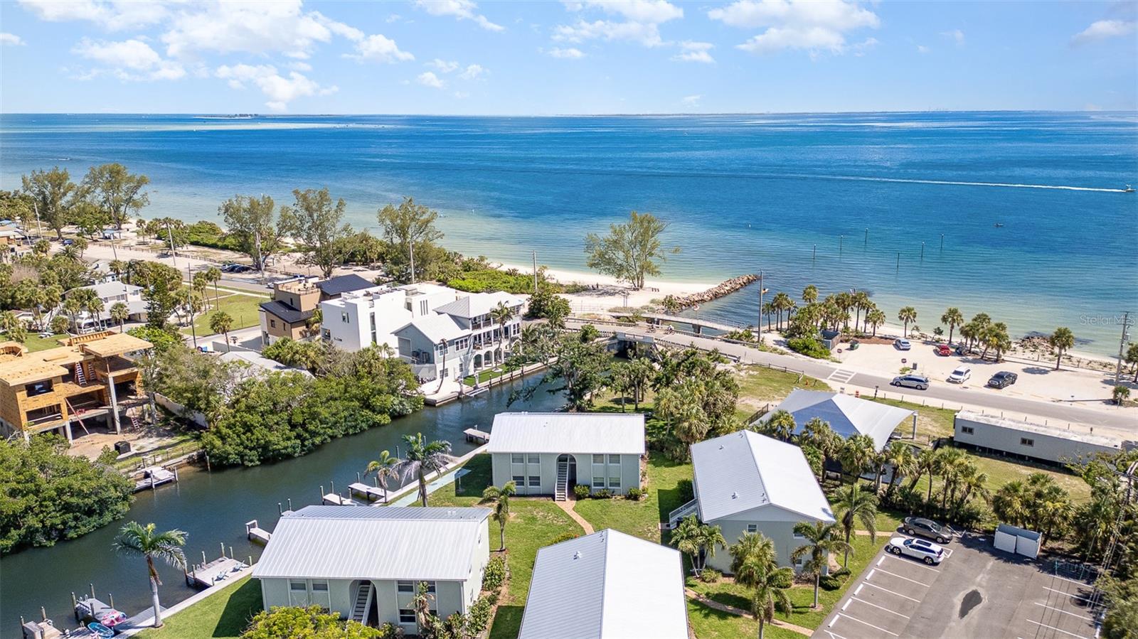 Welcome to your slice of paradise on the north end of Anna Maria Island! One of the most desirable AND currently most affordable WATERFRONT condos located on beloved Pine Avenue. No detail was missed, this lovely light filled 2-bedroom, 1-bath unit has been beautifully renovated and offers the perfect blend of modern comfort and island charm. Unit 8B is privately situated in an end corner unit on a tranquil canal with direct views to Tampa Bay. It includes a deeded boat dock and slip—a rare find in the City of Anna Maria Island. Enjoy morning coffee on the private patio space and manatees and dolphins from your dock. Hop on the boat from your own slip, kayak or paddle board right out to the stunning bay.
Step inside to an open-concept living space and gorgeous eat-in kitchen featuring new stainless-steel appliances and quartz countertops. Offering an airy layout for entertaining family & guests or relaxing after a day at the beach or boating out on the bay. The primary bedroom boasts a spacious walk-in closet, while the second bedroom conveniently includes an in-unit washer and dryer and great bonus shelving in the closet. Ample storage space throughout and there is water views offered from every window in this unit.
Whether you're boating, biking to the beach, or enjoying the boutiques and cafes along Pine Avenue, this condo has it all—location, luxury, and lifestyle. The Bayou has 8 buildings with only 32 units in total. The complex is quiet and meticulously maintained with a lower HOA, new metal roofs in 2025 and newly paved parking in 2024. Perfect as a primary residence, home away from home, or investment property with 2-week rentals. Ideally situated near the trolley stop, or walk to boutique shops, and dining, every island convenience is right at your doorstep. Just pack your bags and get ready to experience island life, offered beautifully decorated and completely turnkey furnished. Don't miss out on this island canal front GEM!