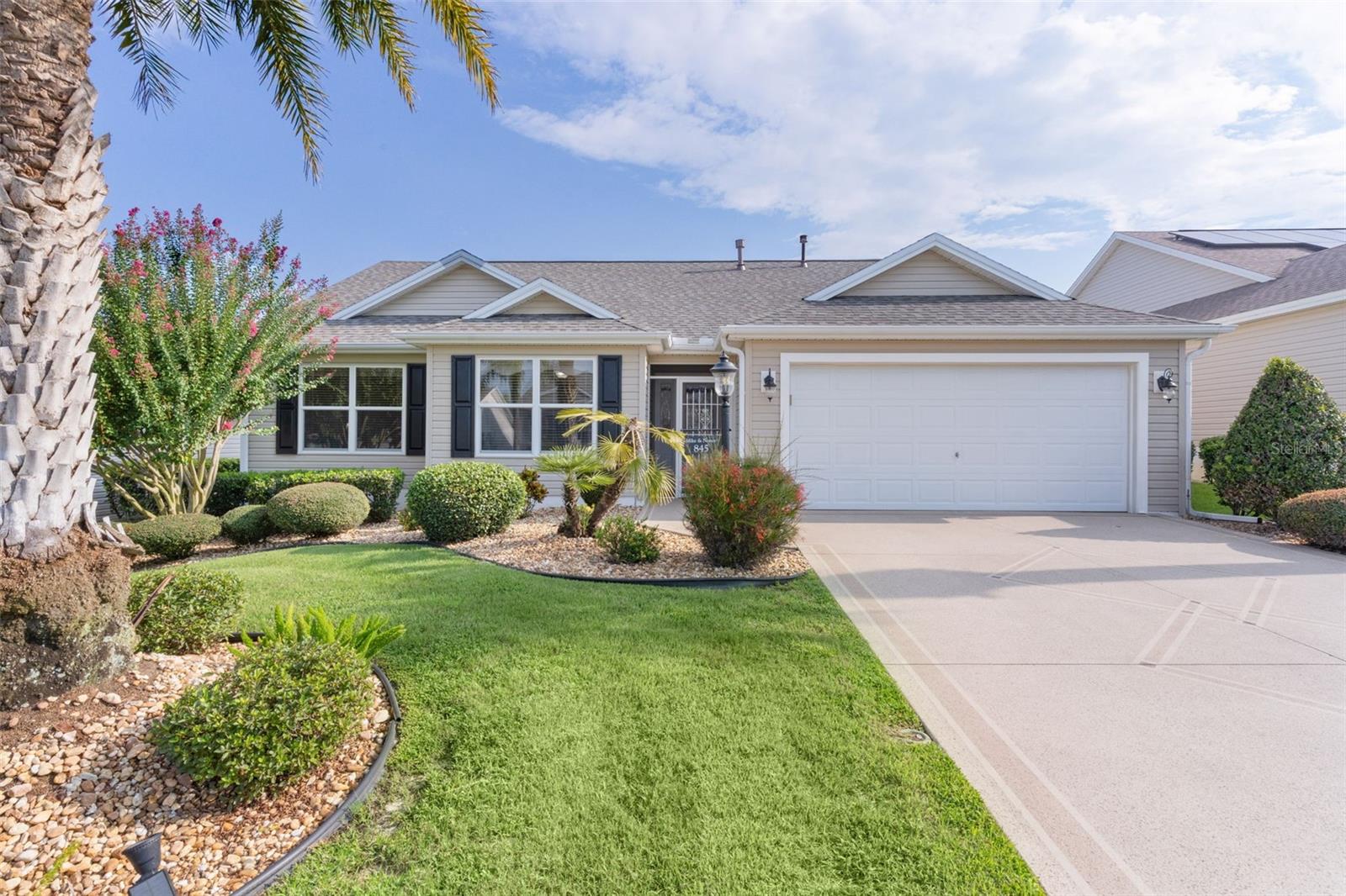 TALK ABOUT LOCATION! This charming Whispering Pine model in the Village of LARGO is ready for you to enjoy! Featuring 3 bedrooms (one without a closet), 2 bathrooms, and a 2-car garage, this home places you approximately an 8-minute GOLF CART ride to LAKE SUMTER LANDING. You’ll also love the convenience of being near Bacall Recreation Center and several golf courses. As you arrive, the painted driveway and mature landscaping create an inviting first impression. Step through the screened entryway and then through double doors with lead glass and into a home that boasts vaulted ceilings and laminate flooring. The living room flows seamlessly into the dining/reading area, offering an open yet distinct layout. The spacious kitchen showcases 3-year-old stainless steel appliances. While the stove is currently electric, a gas hookup is already installed should you wish to convert. Guest bedrooms are nicely sized, with the guest bath conveniently located nearby. The owner’s suite features a walk-in shower and an en-suite bathroom. Enjoy your morning coffee on the screened lanai, or relax knowing several major updates have already been taken care of: New ROOF(February 2025), New HOT WATER HEATER (February 2025), Rebuilt AC outside unit. This home is centrally located with shopping, dining, medical offices, and more just minutes away. The remaining bond is just $11,090.56. Don’t miss this opportunity—call today to schedule your private showing! Here is a link to watch the video. https://media.innovativerepco.com/sites/oprverm/unbranded