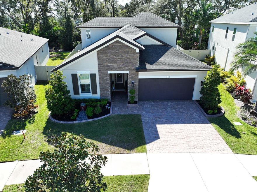 Welcome home to the gated community of Mariposa.  A great location and a great neighborhood.  This Meritage Foxtail floorplan shows like a model.  The 2017 home includes the optional upper floor game room and bedroom/bathroom.  This home also includes the optional 40 foot covered backyard lanai.  All this on an oversized ¼+ acre lot with conservation views.  Pride of ownership is evident throughout the home with details and décor.  All window treatments and light fixtures are included with the home.  The home includes 2933 square feet, 5 bedrooms, 3 baths, a flex room (can be used as a study, office, or a dining room), a game room, and a 2 car garage.  As you enter the home from the paver driveway, you will step in the beautiful elongated hallway that leads to an open floorplan.  The gorgeous kitchen features stainless steel appliances, quartz countertops, 42 inch wood cabinets, a double oven, a separate cooktop, and a large island.  The kitchen overlooks the family room and dining room.  Step outside in the back of the home onto the optional huge lanai and notice your hot tub, large fenced in backyard that extends past the fence, plenty of room for a pool, and peaceful views.  The master bedroom includes a tray ceiling, a walk in closets, double vanities, and a large shower.  The upstairs bonus room is a perfect for a play room or home gym.  The gated community of Mariposa includes a resort style pool, clubhouse, playground, indoor/outdoor entertaining areas with grills, and bar space.  Mariposa is located near restaurants, shopping centers, schools, I-75, the crosstown expressway, and US-301.  Don’t miss this beauty so make your appointment to see this home and the Mariposa community today.