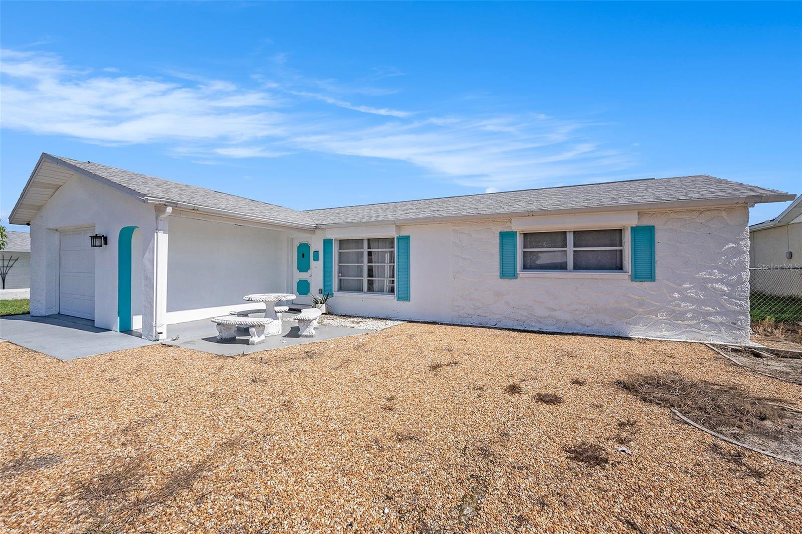 This charming 2-bedroom, 2-bath home with a 1-car garage offers more than meets the eye. It features an additional flex space perfect for a home office, creative studio, playroom, or even a guest room a space that adapts to your lifestyle.
Located in a quiet neighborhood with no HOA, this home is move-in ready and beautifully updated, featuring a new AC system and water heater (2024), and a roof replaced in 2018, which still has plenty of life remaining. You'll love the modern kitchen with stainless steel appliances, updated countertops, and stylish backsplash. The flooring throughout is both elegant and easy to maintain.
Step outside to enjoy a screened-in lanai and a fully fenced backyard - ideal for relaxing, entertaining, or letting pets roam freely and safely.
Located in Flood Zone X - meaning NO FLOOD insurance required and just minutes from shopping, dining, and top-rated schools, this home presents a fantastic opportunity for first-time buyers, families, retirees, or savvy investors.