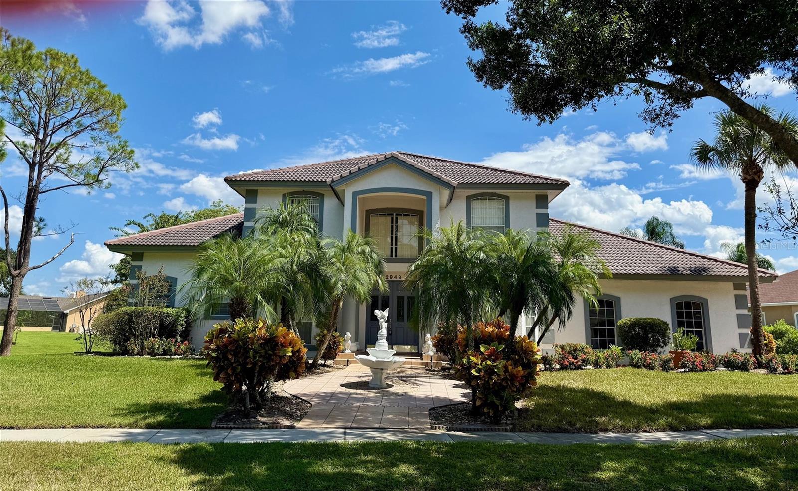 Welcome Home to The Fairways
A Stunning Waterside Oasis in Hunters Creek
Discover a lifestyle of elegance and tranquility in the heart of Hunters Creek, within the prestigious gated community of The Fairways. Upon entering this exquisite enclave, you’re greeted by a stately entrance and tall gates, setting the tone for the luxury and privacy that awaits.
This flamboyant and well maintained home offers a grand first impression, with professionally landscaped grounds, charming walkways, serene fountains, and captivating waterside features. The property is situated on an oversized lot, perfectly positioned along the water to maximize breathtaking views and outdoor enjoyment.
Step through the impressive front doors and into a grand foyer with soaring high ceilings and an open staircase. The formal dining area and living room exude sophistication, ideal for entertaining or intimate gatherings. Pause in the foyer to take in the light-filled space and elegant architectural details.
The family room is designed for both comfort and grandeur, featuring a stately fireplace flanked by multiple sliding glass doors. These doors open seamlessly to the expansive outdoor patio and pool area, creating a stunning "wall of glass" effect that blends indoor and outdoor living.
Outdoors, indulge in resort-style relaxation around the huge pool and spa, enhanced by soothing water features. Over 100 feet of covered lanai and patio space encircle the pool, offering abundant areas for lounging, dining, and entertaining. The dynamic landscaping and panoramic pond views, complete with tranquil fountains, invite you to unwind in your own private paradise.
Inside, the gourmet kitchen is a chef’s delight, boasting new countertops, a spacious breakfast bar, tile flooring, quality cabinetry, and a functional center island. A butler’s prep area with sink adds convenience for hosting, while the large indoor laundry room is equipped with generous cabinetry, a sink, and modern appliances.
The primary suite, ideally located on the first floor, is a serene retreat with large walk-in closets, an expansive bathroom, and a private closet area featuring a separate sink and additional storage. Wake up to sweeping waterside views from your suite, with direct access to the patios, pool, and spa.
This remarkable home offers four bedrooms and two and a half baths, including an oversized two-car garage with side entry and a private door for security and convenience. The property’s privacy is enhanced by its position within the gated community, ensuring peace of mind and exclusivity.
Beyond the home’s luxurious features, enjoy the unbeatable convenience of being just minutes from premier shopping, renowned malls, movie theaters, major airports, world-famous theme parks, and all the major highways that connect you to everything Central Florida has to offer.
Every day feels like a vacation in this beautiful waterside sanctuary—a place where 5 o’clock relaxation on your patio is not a dream, but a daily reality.
Don’t let this extraordinary opportunity pass you by. Contact us today for your private tour and make The Fairways your new address!