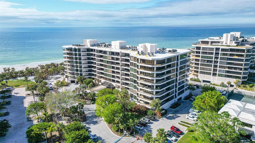 Set upon the pristine sandy shores of Longboat Key, you’ll find the Sanctuary. This community truly lives up to its name as it offers privacy, serenity, and luxury. Located behind the gates of the Longboat Key Club on the south end of the island, this community is sought after for good reason. This stunning 6th floor unit offers a floor plan that features both Gulf and Bay/ City views from the terraces. Truly a sunrise to sunset location! Being offered fully furnished for your convenience, you can move right in and start enjoying this laid-back Florida lifestyle today. From entering the community at the gate, you’ll head to your building which has secured under-building parking and a secured lobby. Your elevator stack shares a foyer with only one other unit, and upon arrival through the double doors you’ll be greeted by stunning oversized tile floors, ceiling detailing with LED recessed lighting, built-ins and modern fixtures. The main living area opens up to a tiled porch with stunning north westerly views over the pool and into the Gulf.  The exterior windows of the unit feature rolldown storm shutters for lock-and-leave peace of mind. The kitchen features stainless steel appliances, ornate stone counters and full backsplashes, gorgeous ceiling and lighting treatments, and access to a rear balcony with stunning views. The primary suite features abundant views, walk-in closet and updated spa-like bath complete with free standing soaking tub and deluxe shower. The fully separate guest suite features en-suite bath, smart updates and great views. The third bedroom or office is currently configured as an open living area- need more privacy? Simply add doors and you have three full bedrooms. The updated powder bath and dedicated laundry room round out this fantastic offering. The Sanctuary offers on-site management, and a host of amenities for you enjoy including har-tru tennis courts, fitness center, meeting rooms, resort style pool with lap lanes, spa, and easy access to miles of pristine beach. Membership to the Longboat Key Club is not required but if desired can add even more to the experience here as it offers golf, a marina, dining, tennis social and much more. This offering is the total package, schedule your private showing today!