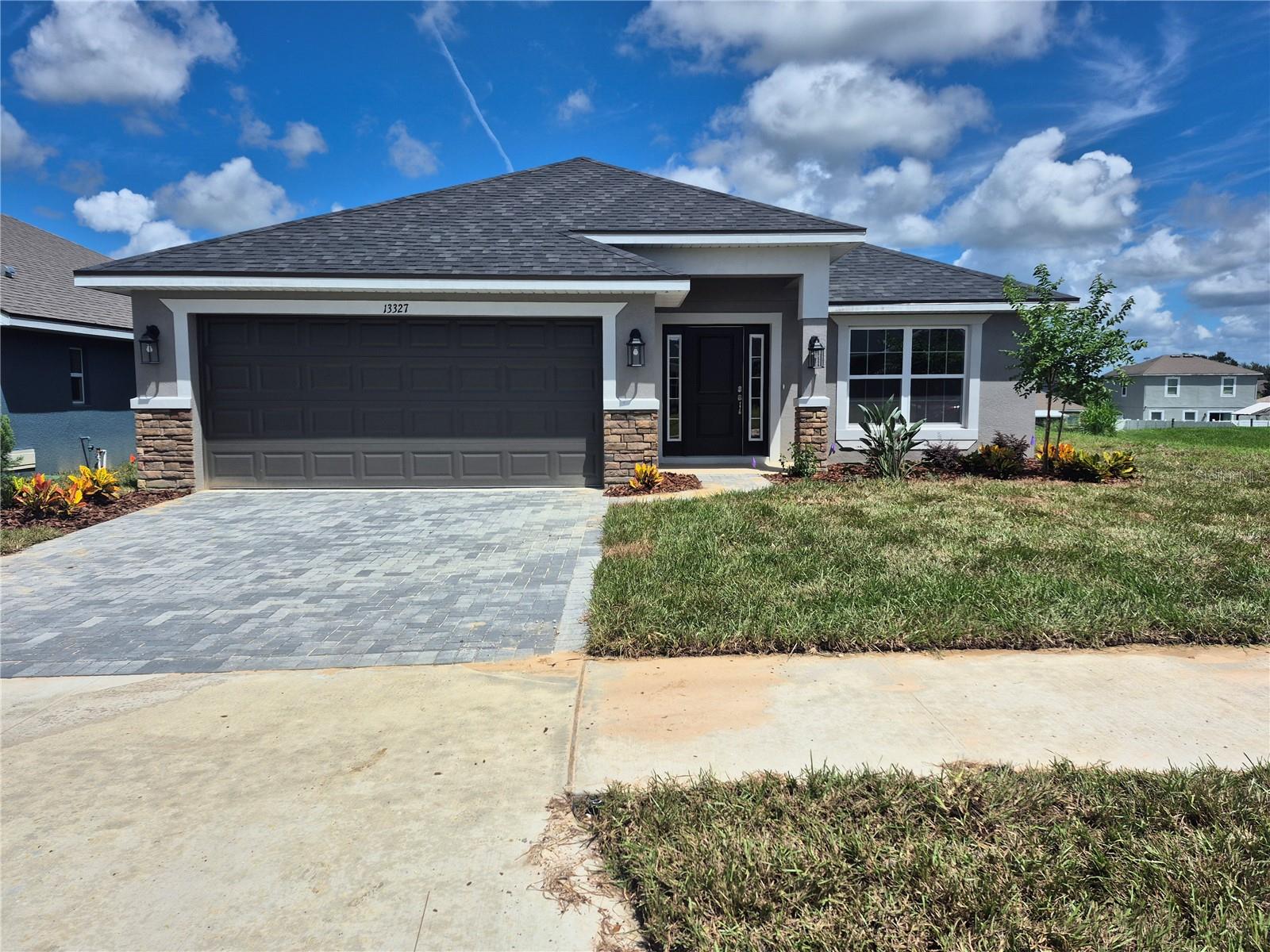 PRICE REDUCTION !! Welcome to Abbey Glen—Dade City’s hidden gem with NO CDD fees and all the charm of brand-new construction! This spacious 4-bedroom, 3-bath home offers 2,200 sq ft of thoughtfully designed living space, with every bedroom featuring its own walk-in closet for maximum storage and style. Bedroom 2 includes a private en-suite bath, making it perfect for guests or multi-generational living. The heart of the home—your kitchen—shines with granite countertops, soft-close cabinetry, stainless steel appliances, and a seamless flow into open-concept living areas with elegant plank tile flooring. All three bathrooms echo the home’s upscale feel with matching granite counters and soft-close cabinetry. The primary suite is a true retreat, highlighted by a tray ceiling with crown molding and a stunning tiled shower with glass enclosure. Additional upgrades include 5¼” baseboards, a 50-gallon water heater, double-pane low-E windows, and the peace of mind that comes with no flood zone concerns. Why wait to build? Your brand-new home in Abbey Glen is ready now—beautifully finished, energy efficient, and move-in ready.