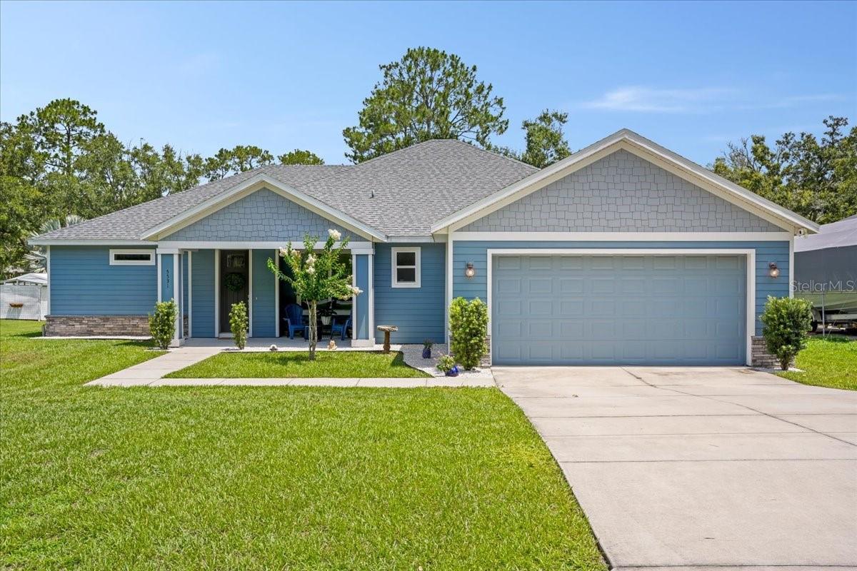 Welcome to your slice of waterfront Florida living! Set on over half an acre, this property blends modern comfort with the freedom of outdoor living—no HOA!. The expansive yard and tranquil water views create the perfect backdrop for enjoying the sunshine lifestyle you've been dreaming of. Built in 2020, this modern-construction home offers peace of mind with high-end finishes and smart design choices throughout. From the moment you arrive, the welcoming front porch invites you to slow down and stay awhile. Step inside, and you're greeted by an open, airy floor plan that’s bathed in natural light thanks to oversized sliding glass doors, perfectly framing the serene canal views out back. The kitchen is as functional as it is beautiful, with a large island, granite countertops, and a spacious walk-in pantry that is ideal for everyday living and entertaining alike. One of the home’s most standout features is its dual-suite layout, designed with flexibility in mind. The primary suite boasts dual vanities, a private water closet, a zero-entry walk-in shower, and two separate walk-in closets. Meanwhile, the mini-master suite offers its own full bathroom and generous closet space, making it perfect for guests, in-laws, teens. A rare layout that supports multigenerational living or short-term hosting without sacrificing privacy or flow. What truly sets this home apart is how effortlessly it extends into the outdoors. Step through the back sliders and you’ll find a large screened-in porch, offering the perfect space to unwind, entertain, or enjoy a quiet Florida evening without the pests. The canal frontage presents tranquil views, with a backyard that feels like a private getaway to waterfront fun. The canal opens to the Palatlakaha water way system, with the two major lakes being Lake Emma and Lake Lucy, ideal for kayaking, fishing, paddleboarding, family outings, and more—right out your back door. When you're ready to explore beyond the backyard, you’re are just minutes away from Arnold Brothers Park & Public Boat Ramp, which features concrete ramp on the Palatlakaha River, with trailer/vehicle parking and ADA-accessible facilities. Other nearby parks include Lake David Park, with two boat ramps, a splash pad, skate park, and open green spaces, as well as Cherry Lake Park, known for its destination playground, basketball court, and picnic area. Conveniently located, near State Road 50 and State Road 19, allowing you ease of access to all of your favorite places for local shopping and dining. Conveniently located near State Road 50 and State Road 19, this home keeps you connected to local shopping, dining, and everything you love about Central Florida, while still offering a peaceful, tucked-away feel. This isn’t just a home, it’s your launchpad to waterside living, multigenerational flexibility, and all the freedom that comes with no HOA rules!