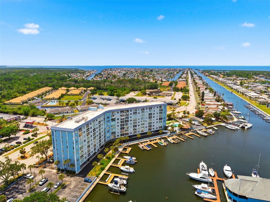 Live the Florida waterfront lifestyle in this beautifully maintained 1-bedroom, 1-bath condo located in the desirable Sea Castle Condominium community within Gulf Harbors. Situated on the 5th floor, this light and bright unit offers stunning canal views leading directly to the Gulf, creating the perfect backdrop for relaxing mornings and peaceful sunsets.

Inside, the spacious floor plan features an open living and dining area filled with natural light, along with a bright sunroom overlooking the water that provides additional living space ideal for a sitting area, office, or reading nook. Unlike many units in the community, this condo features an updated open-concept kitchen with newer cabinetry, quartz countertops, stainless steel appliances, and LED lighting, creating a more modern and functional layout for everyday living and entertaining. The generously sized bedroom offers ample closet space, while additional hallway closets and a utility/pantry closet provide plenty of storage.

Offered fully furnished, this condo is move-in ready and perfect for year-round living, a seasonal retreat, or an investment opportunity. Residents enjoy resort-style amenities including a heated waterfront pool, fishing dock, shuffleboard courts, BBQ and grilling area, library, game room, workshop, secure lobby, laundry facilities, bike and kayak storage, plus an additional private storage closet on the ground floor.

For boating and beach lovers, optional membership is available to the exclusive Gulf Harbors Private Beach Club for just $200 annually, offering private beach access with white sand and breathtaking Gulf sunsets. Nearby public boat ramps and marinas provide easy access for boating, kayaking, and fishing adventures.

The monthly condo fee includes cable, internet, water, sewer, trash, and pest control for truly low-maintenance living. Conveniently located just minutes from downtown New Port Richey, you’ll enjoy easy access to waterfront dining, local shops, entertainment, Sims Park, medical facilities, and the historic Richey Suncoast Theatre. Whether you're searching for a waterfront getaway or a full-time Florida home, this condo offers the perfect blend of comfort, convenience, and coastal charm.
