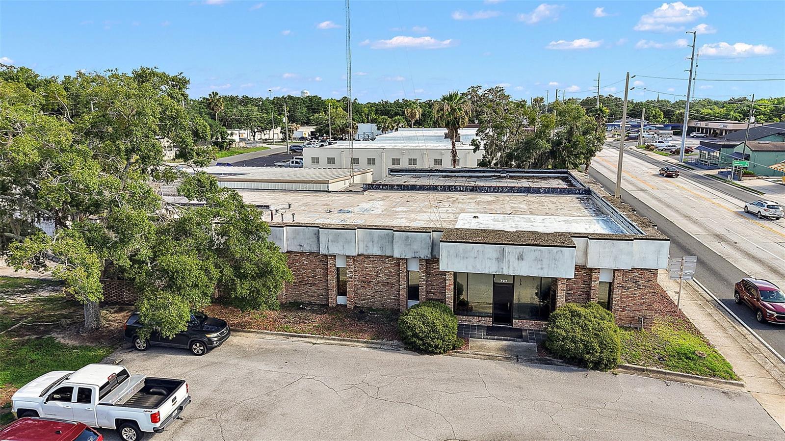 The Main Building is a 14,479 sq ft commercial building located directly on Hwy 27 with over 300 feet of frontages and an average daily traffic volume of 26,500 trips, according to the FDOT website. This exceptional offering includes four properties, all zoned C3/ highway commercial, providing significant versatility for a diverse range of commercial uses. The main building consists of over 20 private offices, multiple conference and storage rooms, a warehouse equipped with a roll-up bay door, several restrooms, and a fenced in parking area. This building could be made into two units with independent parking and entrances. There is an existing firewall and two monuments’ signs. The adjacent 0.67-acre commercial parcel with direct frontage on Hwy 27, presenting an optimal opportunity for expansion or future development. Both parcel and Property benefit from dual ingress and egress points via Hwy 27 and Lynch Avenue to the rear of the property. Other features include a long-range radio tower, a substantial walk-in safe, city utilities, and access to public transportation close by. Also included with the offering is a 750 sq ft, two bedrooms and one-bathroom, residential home located at 715 Lynch Avenue and a 0.10-acre vacant parcel at 713 Lynch Ave, positioned to the rear of the main commercial building. This property offers potential for on-site residential use, generates rental income, additional parking or can be developed into additional commercial space. This property’s central location with high visibility and easy accessibility makes it a great location for your business. Property 1: Main Building (Alt Key # 1346819), Property 2: Adjacent Commercial Lot (Alt Key # 1346801), Property 3: Residential Home (Alt Key # 1346754), Property 4: Vacant Lot (Alt Key # 1346762)