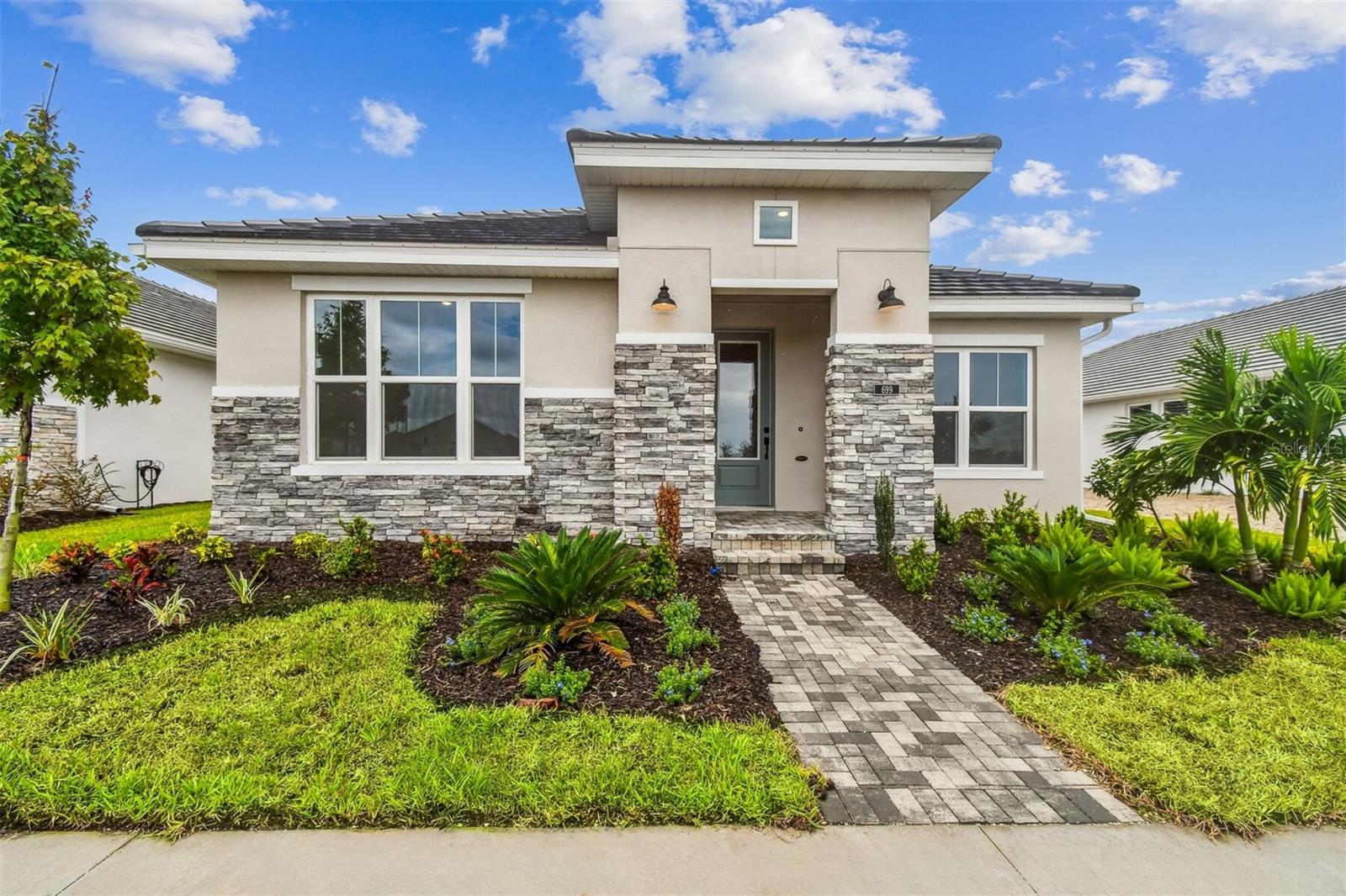 Welcome to the Mapleton by David Weekley Homes—a thoughtfully designed 3-bedroom, 2-bath home with an enclosed study and 2,004 square feet of smartly utilized space. This floorplan lives larger than its size, thanks to a wide-open layout and seamless indoor-outdoor flow.
Enjoy cooking and entertaining in the oversized kitchen, featuring abundant countertop space ideal for prepping and hosting. The expansive living area is filled with natural light, courtesy of oversized hurricane-impact windows throughout—creating a bright, inviting atmosphere while offering peace of mind and energy efficiency.
Step outside to your extra-large lanai, perfect for relaxing or entertaining year-round. A unique feature of this home is the detached garage located at the rear, providing both curb appeal and practical functionality.
Low-maintenance living is made easy with lawn care included, so you can spend more time enjoying the vibrant community amenities. Residents have access to a resort-style pool, fitness center, game room, and a dedicated lifestyle director who curates community events and activities.