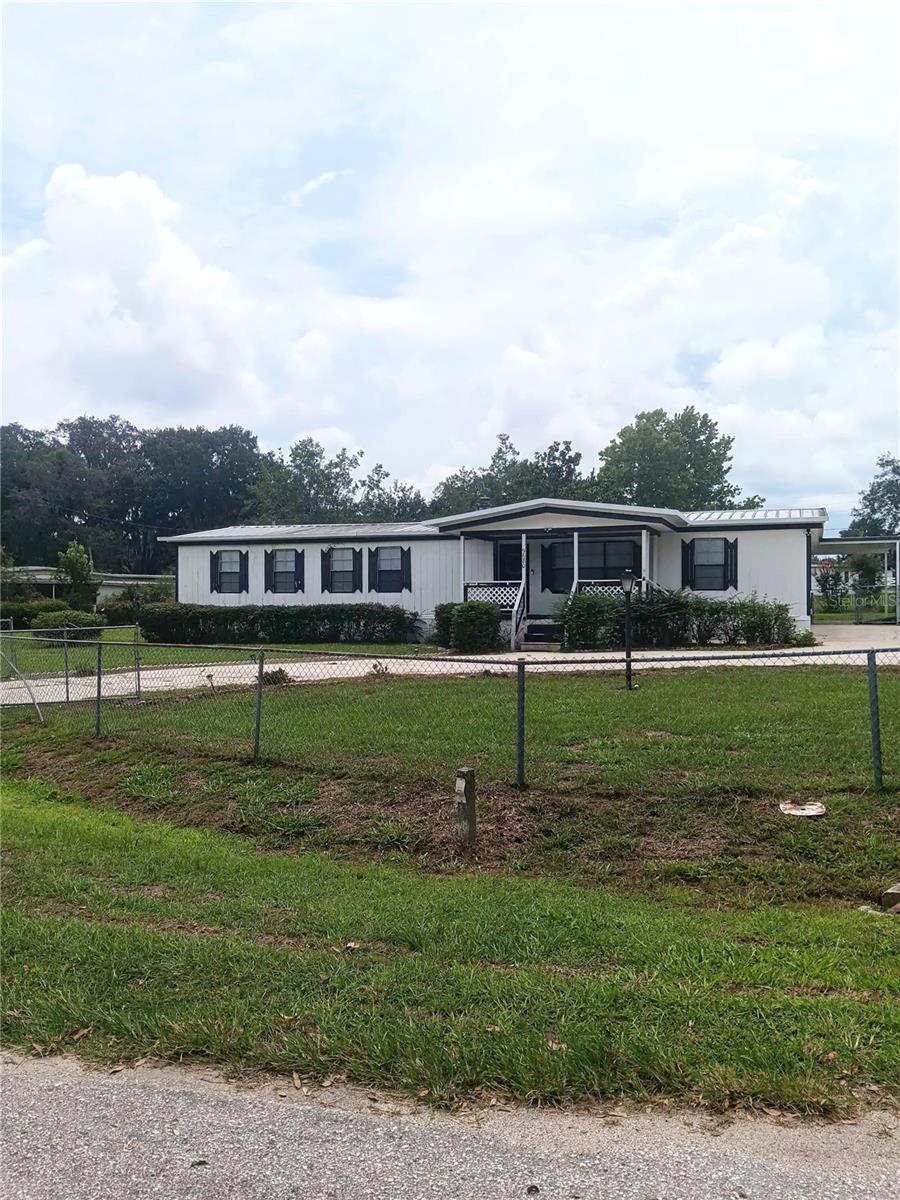 This is a sweet spot! Corner double lot at .45 acres. Fully fenced chain link with wide gates allowing for RV or boat access to yard, family events, pets and gatherings Southern style porch in front and extra large covered cement patio in backyard that welcomes a comfy rocking chair, BBQ and lounging! The spacious interior offers a working built in firepalce. Kitchen has stainless steel refridgerator and a dishwasher. Living room is designed with a lovely bay window offering an open green space view. Oversized bedroom has a walk in closet & (3) windows. Feel free to add a built in pool or place an above ground as there is plenty of open area. Engage in the private KOI pond as well! Workshop supplies ample room for stortage or activities. This home has endless options! Additional photos available by 7.24.2025. All measures to be confirmed by Buyer