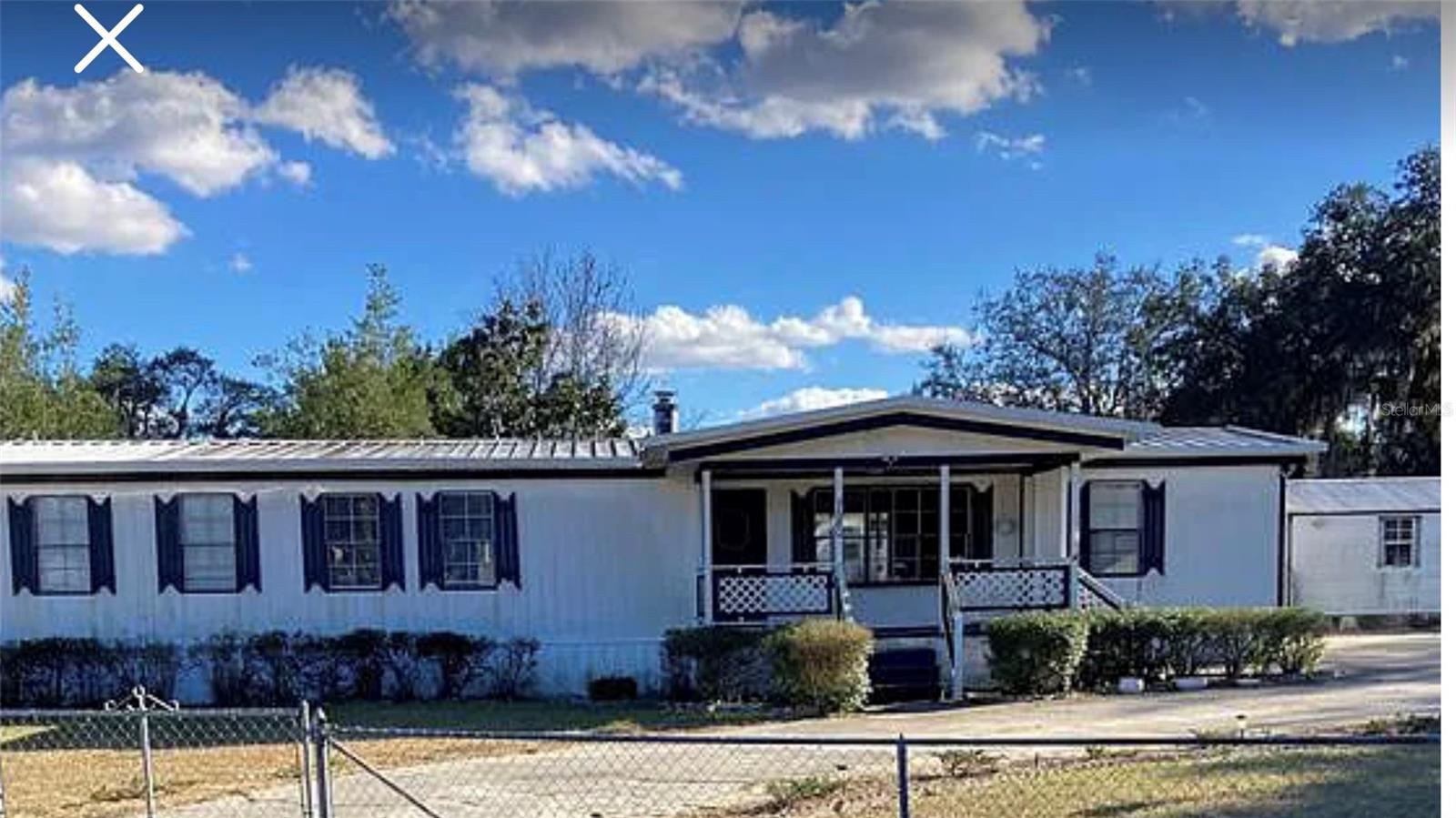 This is a sweet spot! Corner double lot at .45 acres. Fully fenced chain link with wide gates allowing for RV or boat access to yard, family events, pets and gatherings Southern style porch in front and extra large covered cement patio in backyard that welcomes a comfy rocking chair, BBQ and lounging! The spacious interior offers a working built in firepalce. Kitchen has stainless steel refridgerator and a dishwasher. Living room is designed with a lovely bay window offering an open green space view. Oversized bedroom has a walk in closet & (3) windows. Feel free to add a built in pool or place an above ground as there is plenty of open area. Engage in the private KOI pond as well! Workshop supplies ample room for stortage or activities. This home has endless options! Additional photos available by 7.24.2025. All measures to be confirmed by Buyer