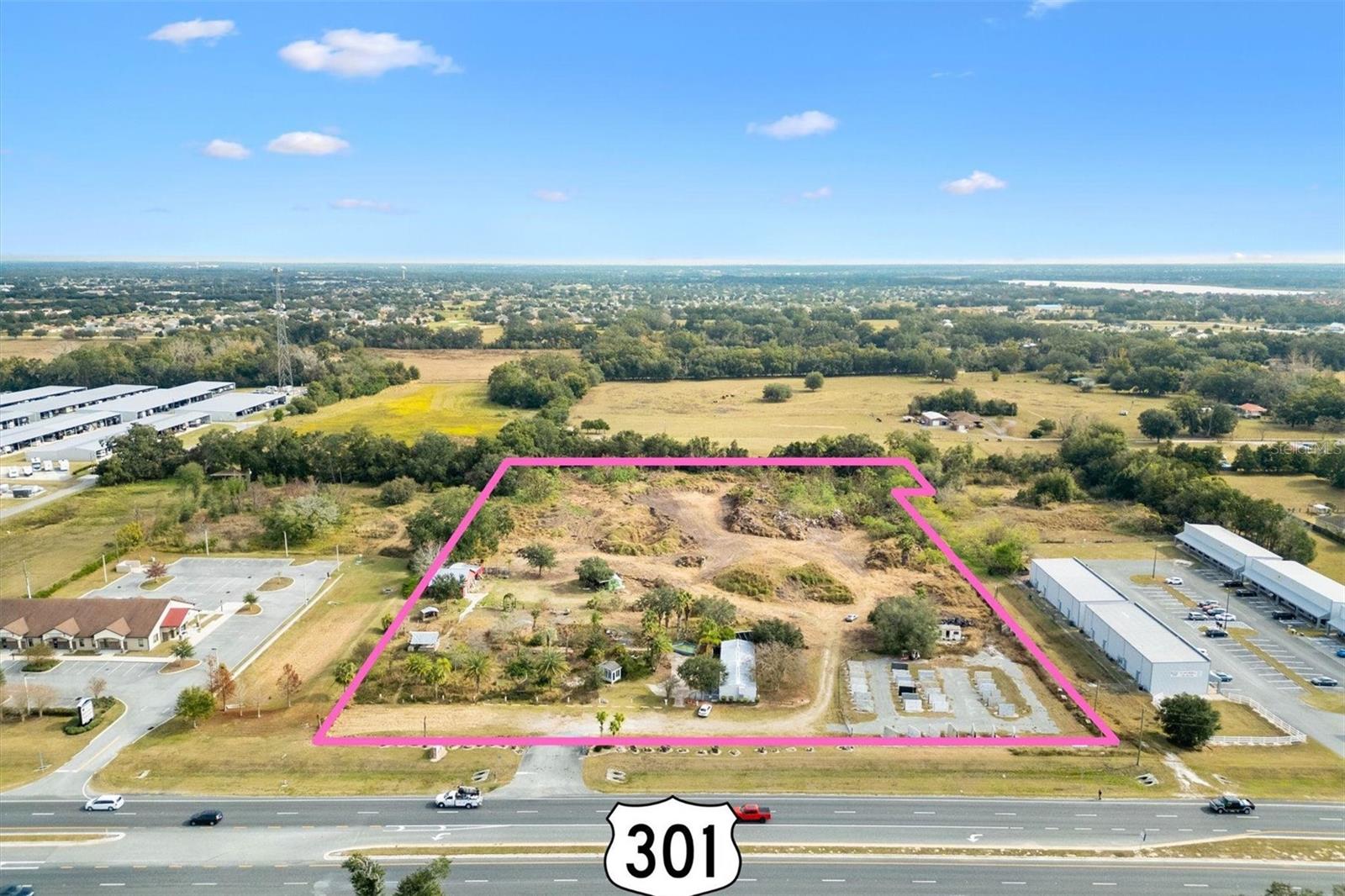 Strategically located on high-traffic HWY 301 with an Average Daily Traffic Count (AADT) of 36,500, this 7.47-acre parcel offers unmatched development potential in the heart of The Villages/Sumter County MSA. Boasting approximately 468 linear feet of highway frontage, the site provides excellent visibility and accessibility, including a median cut for seamless ingress and egress from both north- and southbound lanes. Zoned C-3—the most intensive commercial zoning—this property allows for a wide range of uses, including retail centers, medical plazas, warehouses, storage facilities, multi-family developments, and more. City of Wildwood water and sewer connections are available, streamlining the development process. Conveniently positioned near CR 466, CR 466A, Wildwood, and several major new developments, the site is well-connected to the region’s growth and demand. The owner is open to subdividing and selling smaller pads, offering flexible options for investors and developers alike. Don’t miss this exceptional opportunity to bring your vision to life. Contact us today to explore your options!