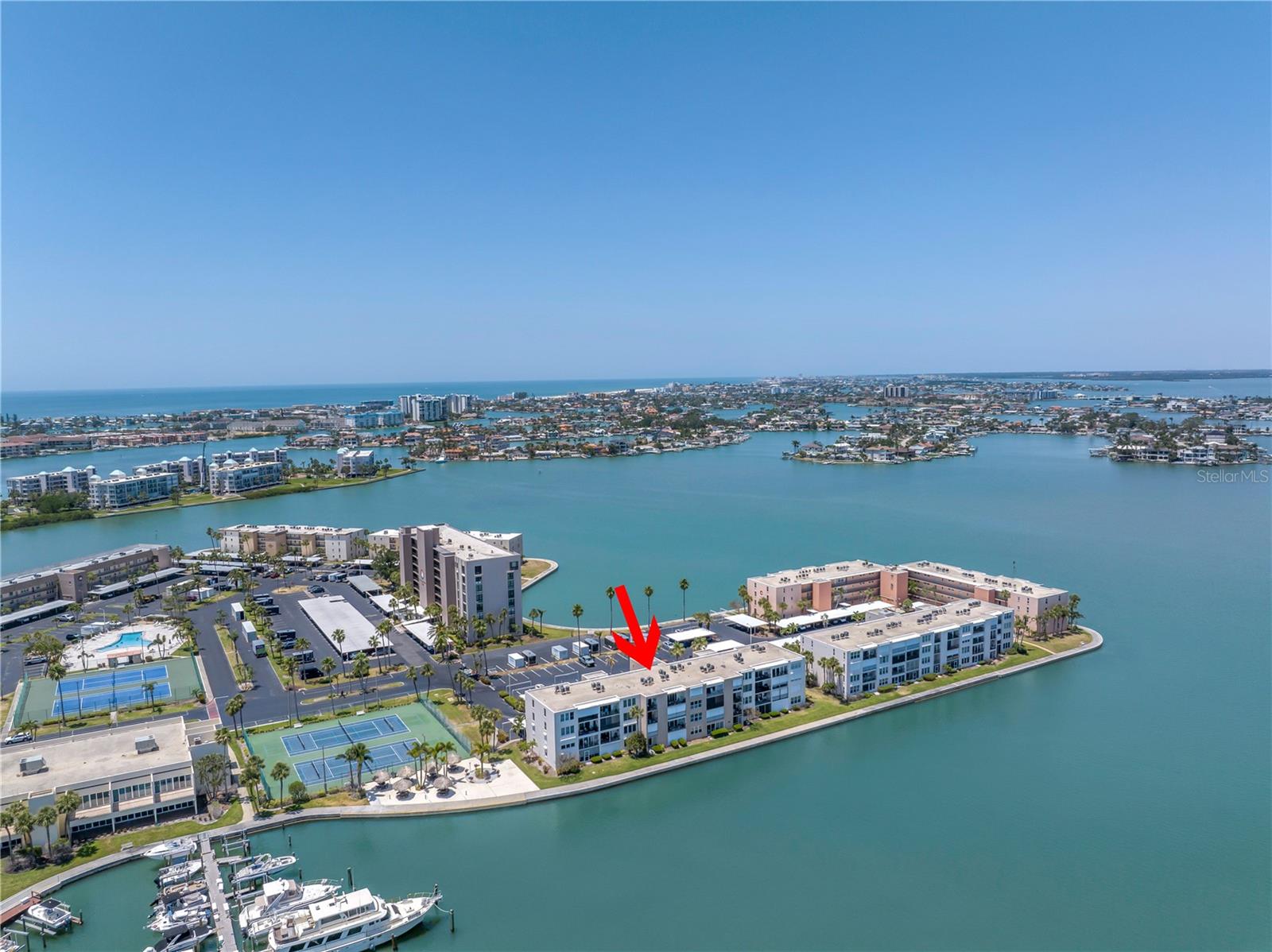Welcome to the beautiful community of Bay Island. This unit located in the Heritage Building is directly on the water. The unit had minimal water intrusion during Hurricane Helene with no interior damage however the condo and all the first floor units are being remediated by the association to ensure all first floor units are fully renovated and free of storm damage. The cost of remediation is being covered by the HOA and a renovation finish package with details is available for review with COMPLETION SCHEDULED for September 2025. A weekly progress report of scheduled of repairs is being provided for clear communication. This first floor unit has an open floorplan with living, dining and kitchen. The bathroom has a walk-in shower with white subway tile. The bedroom has a walk-in closet and sliding door that opens to a screen enclosed covered porch overlooking the water! Flooring, kitchen finishes, appliances and bathroom finishes will be re-installed and covered by the community under their flood insurance coverage. Depending on timing, this may allow the buyer to choose their preferred options. This 24-hr guard gated waterfront community has an exceptional array of activities for the active resident including multiple pools & spas, tennis & pickleball courts, community room with activities such as yoga, entertainment and socials, shuffleboard courts, fitness center with sauna, waterfront tiki huts with grilling area and community marina for fishing or boating opportunities. The indoor amenities are in process of remediation and photos are pre storm for reference. Bay Island is a 55+ community. Ask for more details on this exceptional value condo.