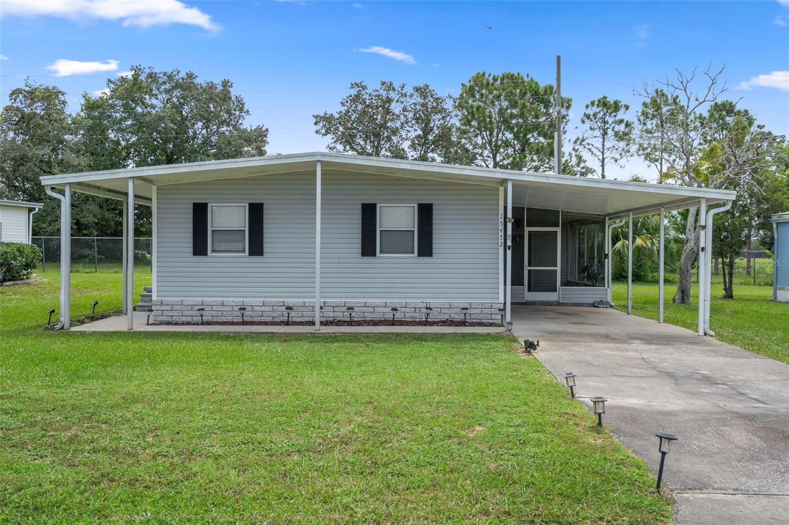 Welcome to this beautiful completely renovated furnished 3-bedroom, 2-bath home with no rear neighbors located in one of the area’s most sought-after, gated golf course communities with a 24-hour live guard at the entrance for peace of mind. This home combines modern updates with a relaxed Florida lifestyle and features a golf cart garage/workshop, carport, and a screened patio—perfect for enjoying the outdoors. Inside you’ll find a kitchen with large center island and updated cabinets and appliances. Split bedroom design allows privacy with the primary bedroom at one end of the home and 2 additional rooms at the other. Enjoy resort style living within a community that features an abundance of amenities to keep you active, social, and entertained. Residents enjoy access to a private Par 72 golf course, heated swimming pool, sauna, clubhouse with exercise room and classes for just about everything. For sports and recreation, there are tennis and pickleball courts, shuffleboard, bocce ball, and horseshoe pits. Creative and social outlets abound with a ceramics studio, library, computer lab, over 100 clubs, social dances, and weekly bingo nights. An RV and boat storage compound is also available for your convenience. Whether you’re looking to stay active, meet new friends, or simply relax in a vibrant setting, this home and community have it all.