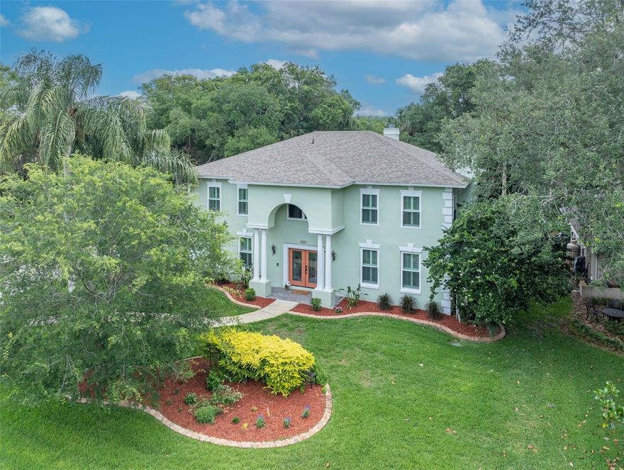 BEAUTIFUL, UPDATED Six-Bedroom, Four and one-half Bath Executive Pool home in Tuscawilla’s sought-after Chelsea Woods community with its tree-canopy lined streets! This unique home has no back neighbors, no required HOA & offers TWO PRIMARY BEDROOMS (one on each level) & a third bedroom with ensuite bath access! This fabulous home sits on an oversized lot with a wooded green space behind it & is zoned for Top-Rated schools including Oviedo High. This home features a REMODELED KITCHEN, REMODELED PRIMARY BATHS, & boasts numerous updates: NEWER ROOF (2021); LOW-E DOUBLE PANE WINDOWS (2022); TWO NEWER HVAC SYSTEMS (2021); Two NEWER WATER HEATERS (2024 & 2025); RESURFACED POOL with FULLY PAVED DECKING & Newer variable speed pool pump; Freshly painted exterior (2023); PLANTATION SHUTTERS; CROWN MOLDING; KNOCK DOWN CEILINGS; upgraded Security System; and a whole-house WATER SOFTENER. The Kitchen is a chef's dream, showcasing elegant two-tone cabinetry, granite counters, a stylish stone backsplash and soft-close doors & drawers. Enjoy casual meals at the island's breakfast bar & dine in style under crown molding in the spacious Dining Rm, complemented by Plantation Shutters here and in several other rooms. First Floor flooring is upgraded with large porcelain tile throughout, with the exception of the rich engineered hardwood floors in the Primary Bedroom. The first floor Primary Bedroom remodeled bath features a zero-entry shower with newer tile, tall cabinets with granite counters & dual sinks. Beautiful hardwood stairs lead the way to the upper floor, where the Primary Bedroom here also features a remodeled bath with a generous sized shower with dual showerheads, a separate bath & tall cabinetry with granite counters. The other 4 Bedrooms upstairs are generously sized, with one having direct access from the Primary Bedroom, making it perfect as a nursery, office or gym. With 14 closets in this home there’s no shortage of storage! This home offers warmth as well as charm with TWO FIREPLACES—one in the Living Rm and one in the Family Rm. The Family Rm is open to the kitchen & features sliding glass doors that open to the spacious lanai & pool. Step outside to a beautifully resurfaced pool area with brick paver decking, a screen enclosure & a large covered patio—perfect for outdoor gatherings! The fully-fenced backyard sits on over a 1/3 acre lot & backs up to a peaceful wooded green space. You will appreciate the interior Laundry Rm with its utility sink, the large pantry closet, the extra room in the 2-1/2 Car Side-Entry Garage, pull down attic stairs, the stylish landscape curbing and the EXTENDED DRIVEWAY – perfect for keeping extra vehicles. This fabulous home is located close to 417/426/434, UCF, Siemens, Research Park, Oviedo Hospital & Oviedo Mall for easy commuting. It is centrally located in highly desirable Tuscawilla and is close to several parks, the 29-mile Cross-Seminole Trail & is within a mile of the Tuscawilla Country Club, where Golf, Tennis & Social memberships are available at this beautiful, recently renovated private course. In addition to golf & tennis, there’s a Jr. Olympic sized pool, clubhouse, pro shop, fitness center & restaurant. This is truly a perfect place to call home. Don’t delay in calling for your PRIVATE SHOWING of this beautiful, executive home, perfect for a large or multi-generational family!